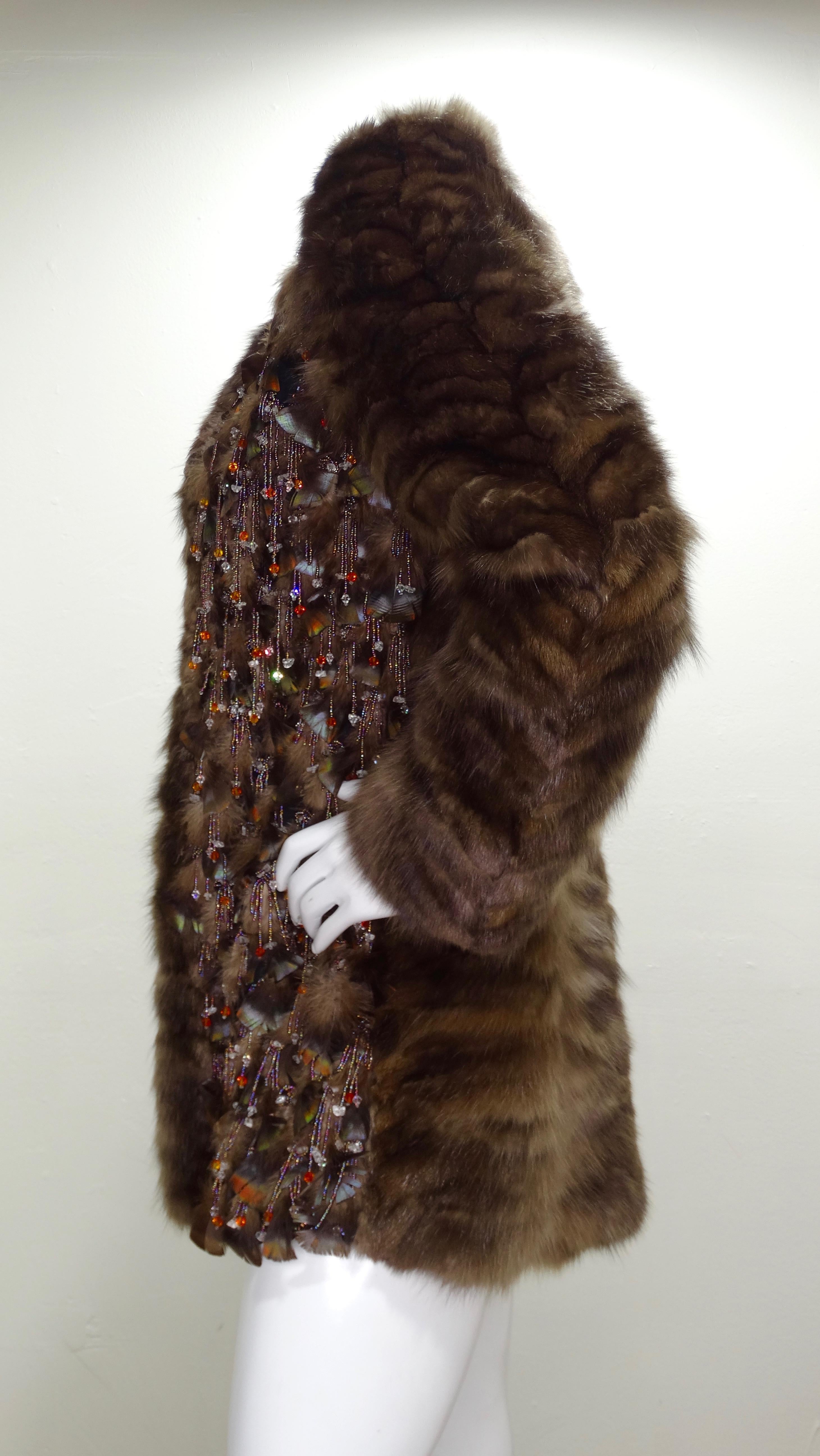 Stay cozy while looking amazing in this Oscar de la Renta fur coat! Circa recent 2000s, this coat is crafted from ultra soft Sable fur and is adorned with feathers and multi-colored beaded fringe. Interior is lined with olive tone Silk. Unique and