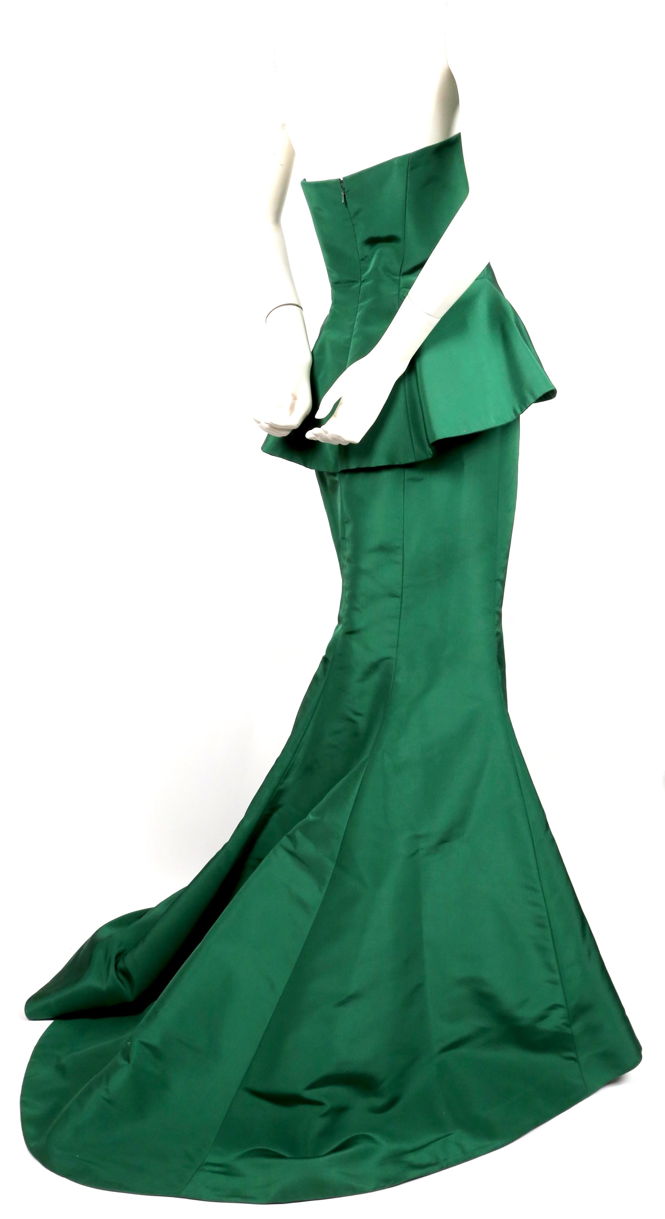 Emerald-green, silk gown with pleated bodice and long train designed by Oscar De La Renta exactly as seen on the resort 2013 runway. Labeled a U.S. size 8. Approximate measurements:  bust 35