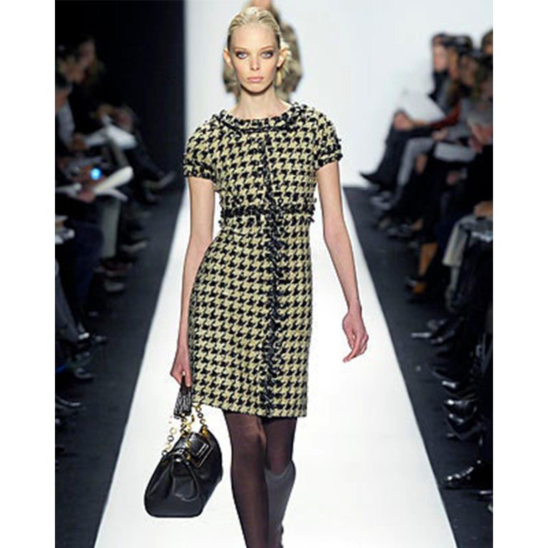 This is a fabulous Oscar de la Renta alpaca and wool check dress featured on the Fall 2007 Runway. .This great dress has a beautiful vertical check knitted print in white, black, and brown. The trim of the dress and details throughout are all