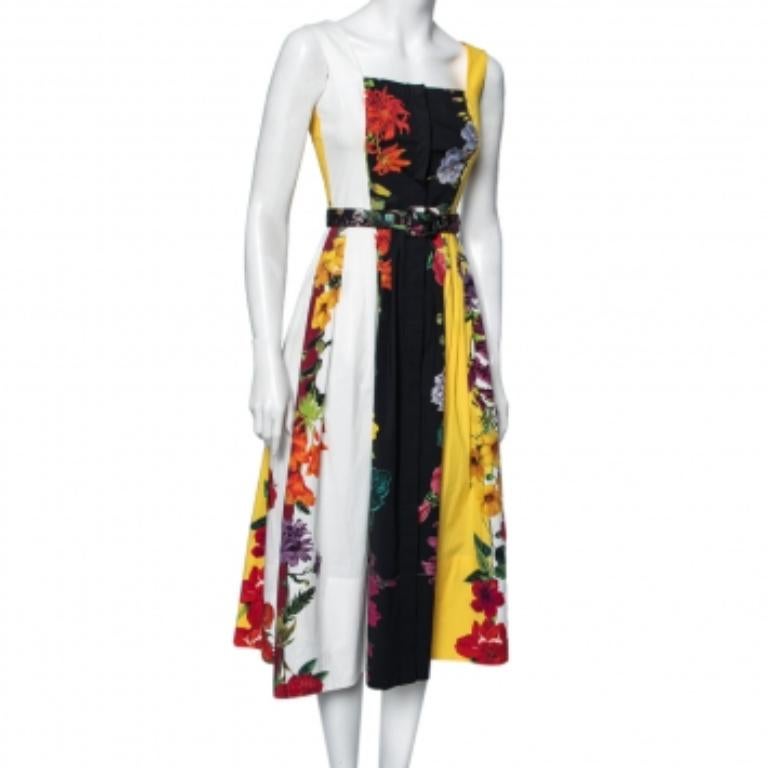 Oscar de la Renta brings you this beautiful dress to flaunt elegance and grace no matter what! It is designed using multicolored floral printed cotton fabric, which is embellished with pleated formations and a button-front feature. It has a belted