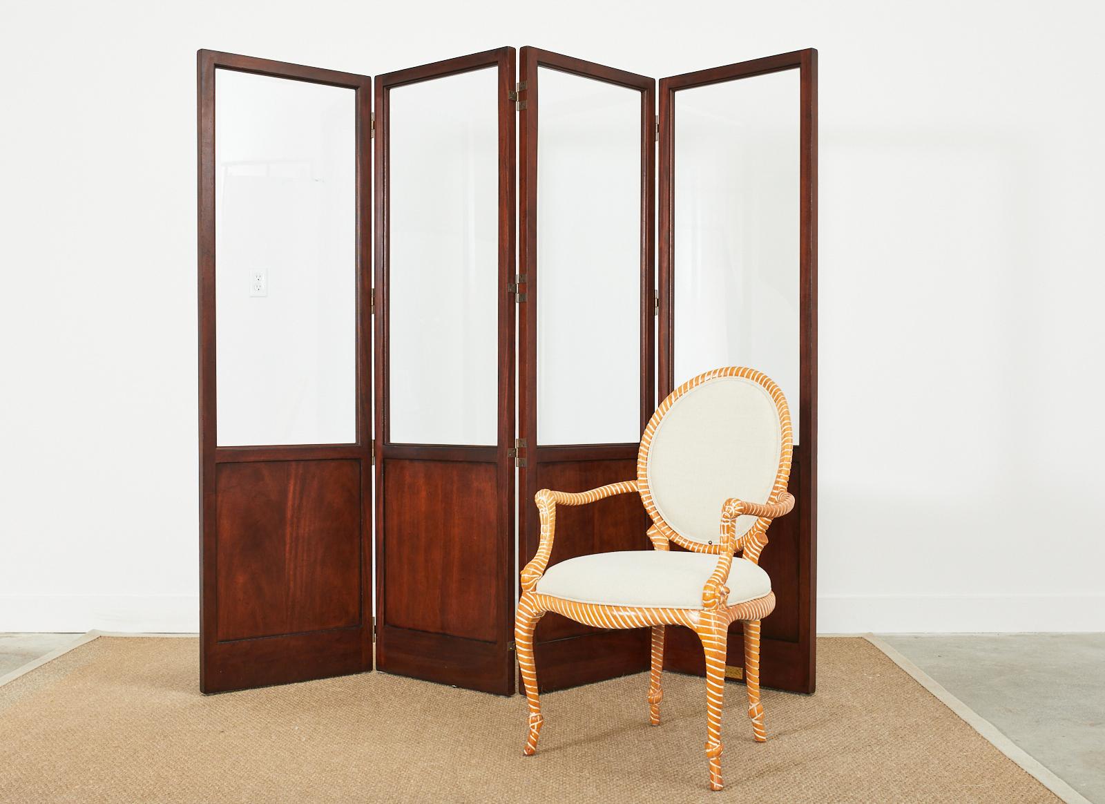Distinctive four panel mahogany folding screen designed by Oscar de la Renta for Century Furniture. The screen features thick panes of beveled glass inset into heavy mahogany panels with a rich dark finish. The mahogany has a very subtle