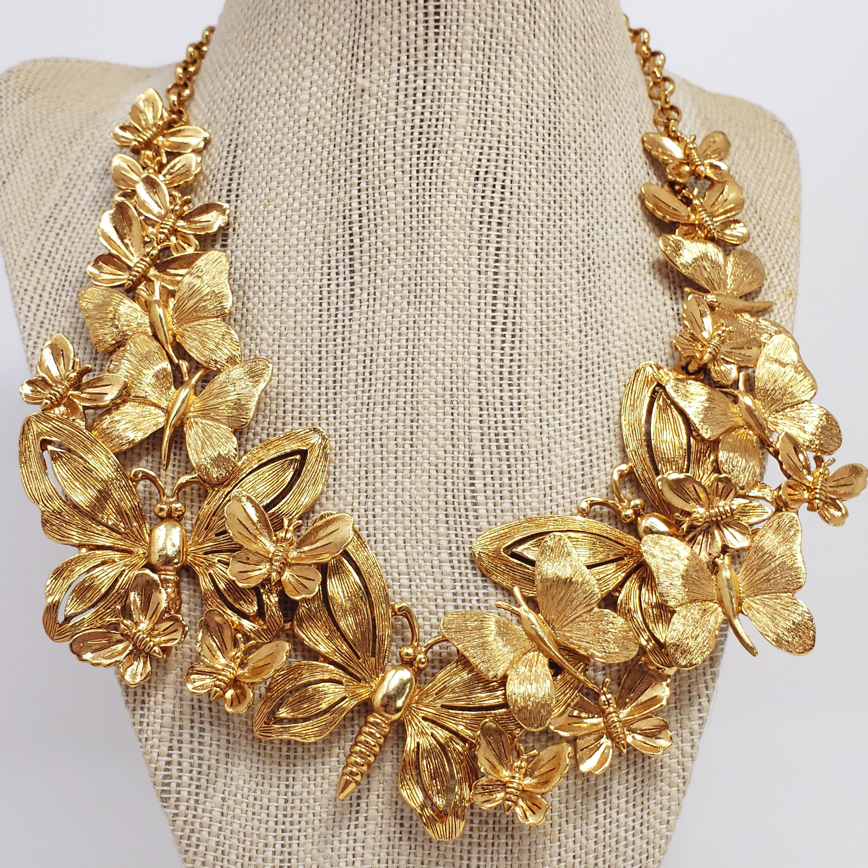 A bold and bright necklace by Oscar de la Renta. The stylish design features an assortment of butterflies. In textured gold finish. Fastened with crab claw clasp and rolo chain.

Length: 12