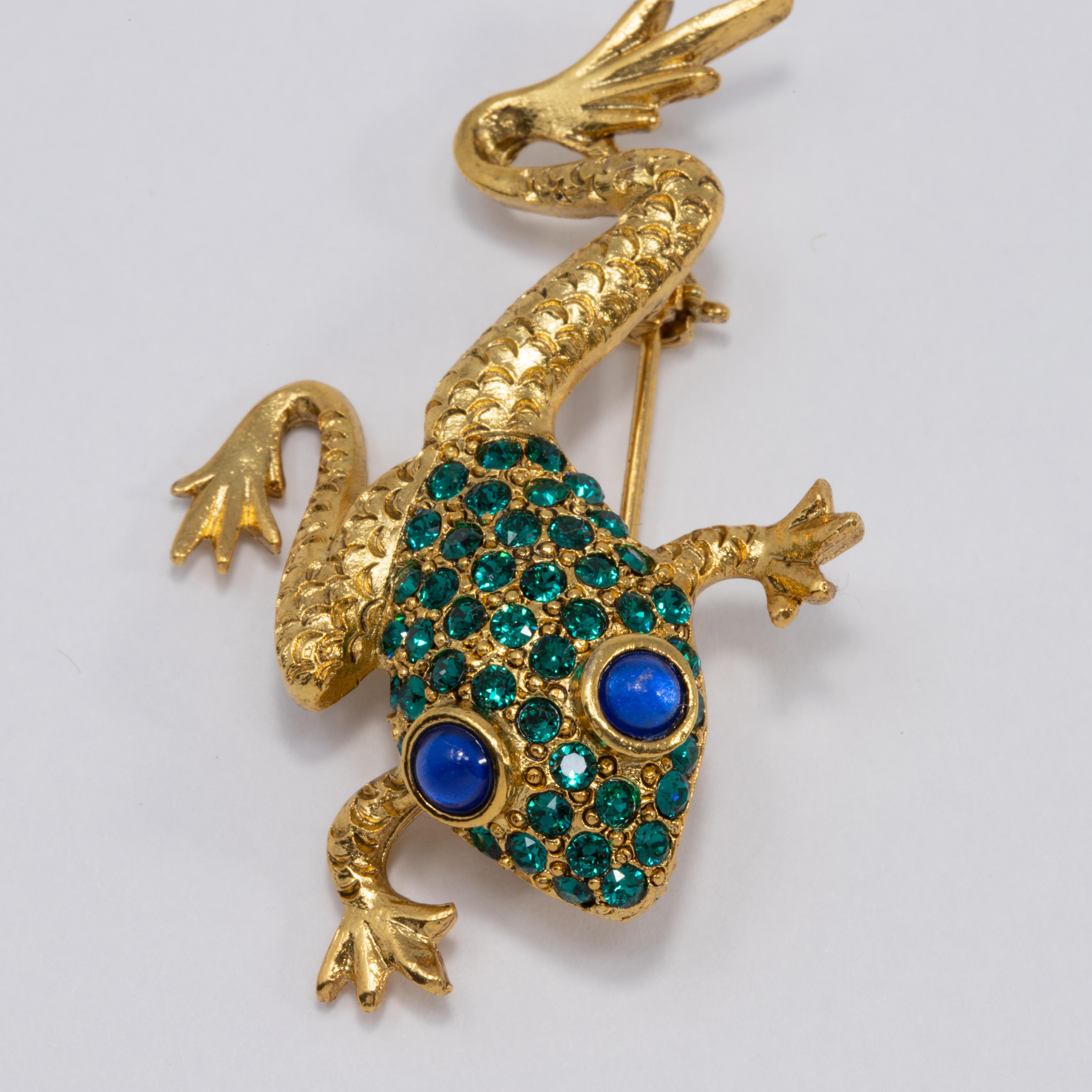 A quirky pin/brooch by Oscar de la Renta! This little gold-tone frog is decorated with pave green crystals and two mesmerising blue cabochon eyes.

Hallmarks: Oscar de la Renta, Made in USA