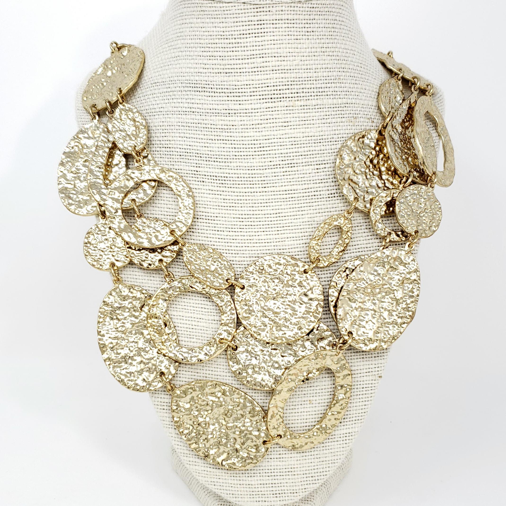 A bold statement necklace from Oscar de la Renta, sure to get compliments! 

Three strands of golden hammered discs and rings on a chain necklace.

Hallmarks: Oscar de la Renta

Length: 18 to 22 inches
