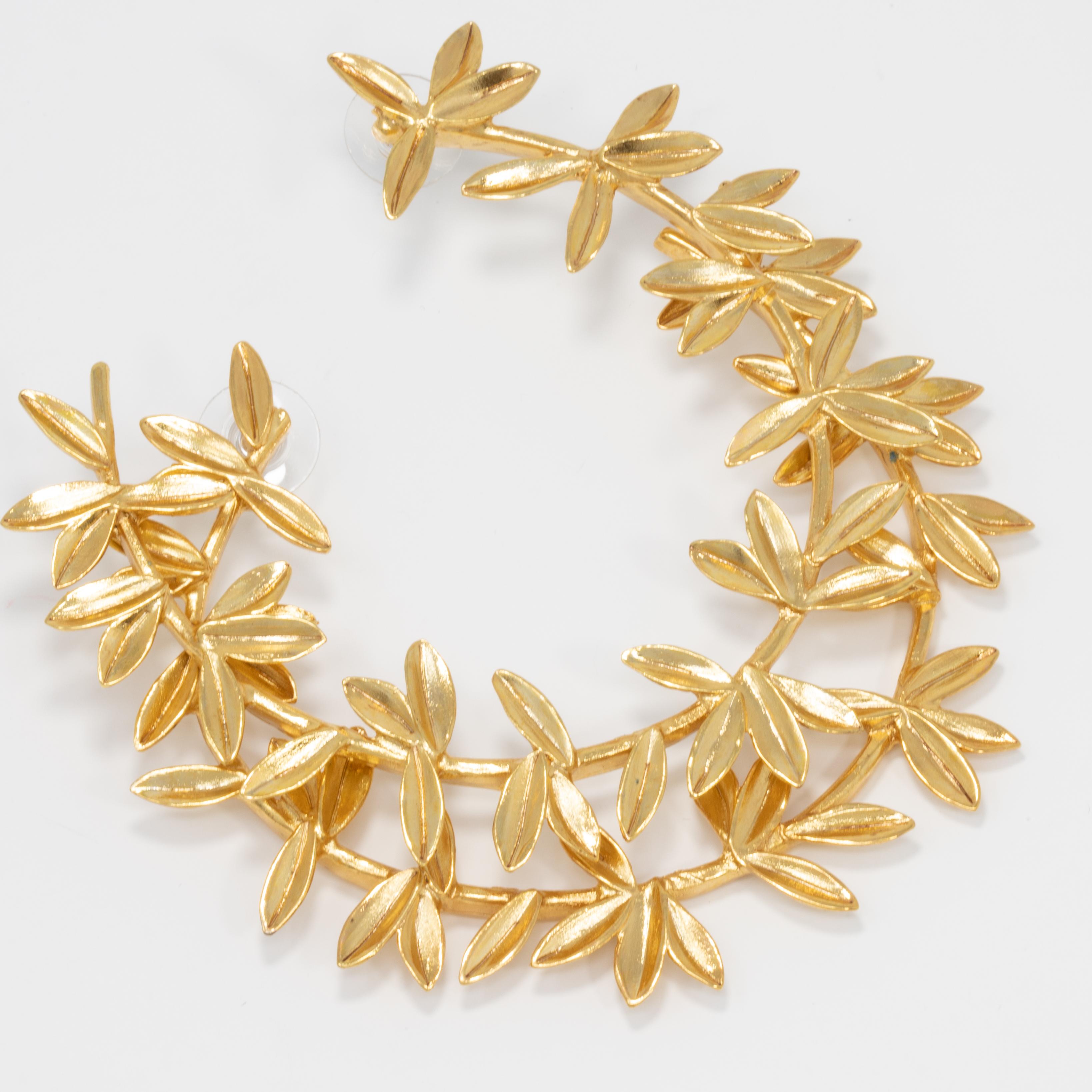 Large, bold, statement flower open hoop earrings by Oscar de la Renta. Add a golden glow to your outfit!

Gold plated. Post backs.

Hallmarks: Oscar de la Renta, Made in USA