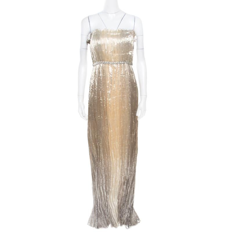 From Oscar de la Renta's Spring 2012 Ready-To-Wear collection comes this dazzling dress accompanied by a cropped jacket. Both are made with gold lurex and they shimmer beautifully. The jacket has a textured design and the strapless dress has a