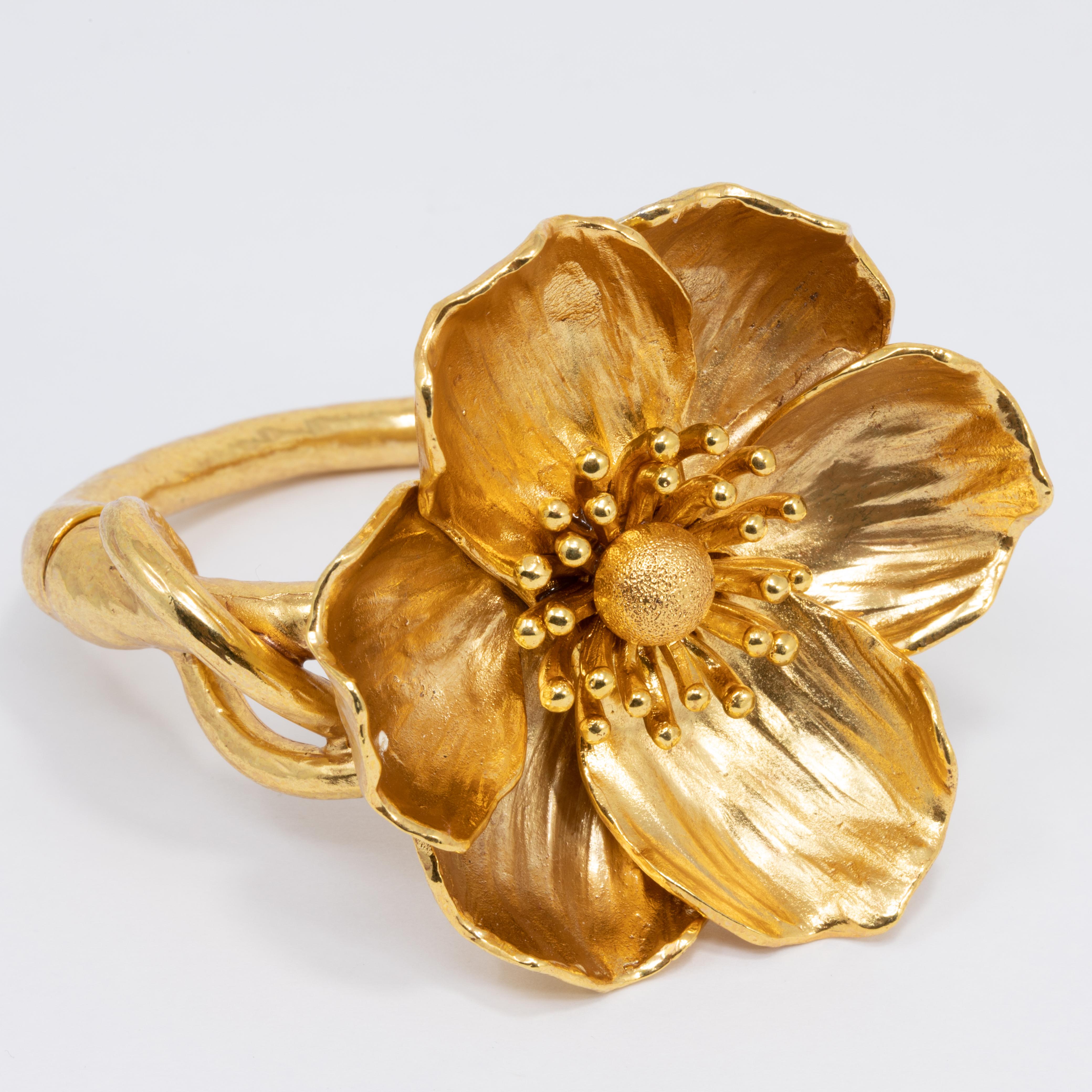 Poppy flower bracelet by Oscar de la Renta. Gold-plated pewter hardware with magnetic closure. Poppy silhouette with brushed finish. Approx. 2.5