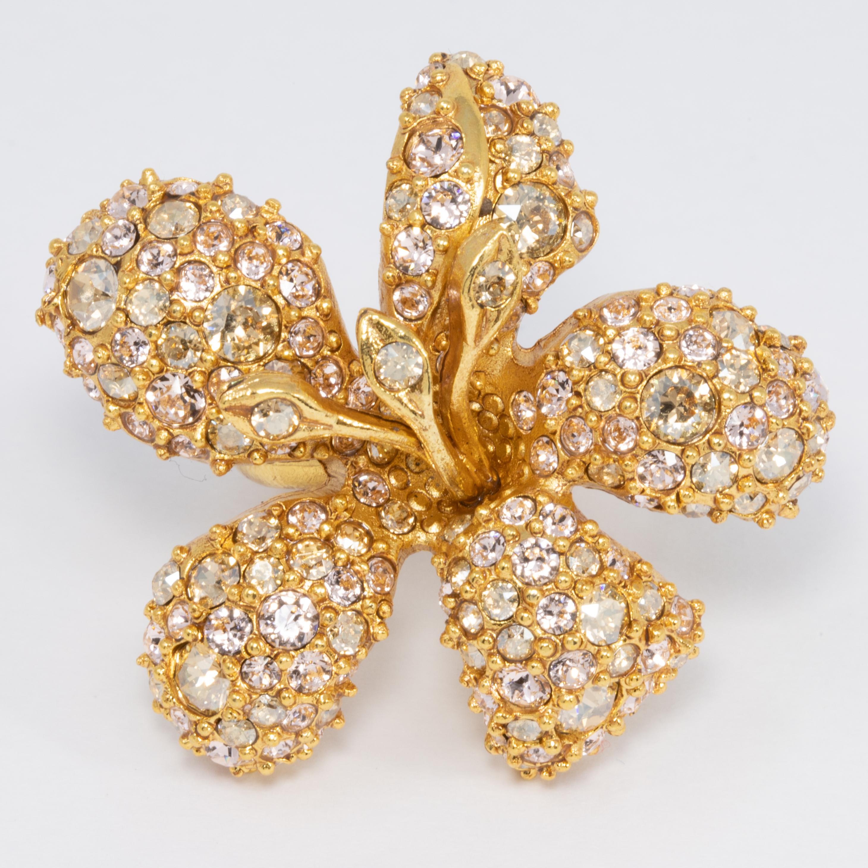 Champagne colored pave Swarovski crystals decorate this glowing golden flower ring. A touch of tasteful extravagance from Oscar de la Renta!

24K Gold-plated.

Adjustable sizes 5 to 8.5

Tags, Marks, Hallmarks: Oscar de la Renta, Made in USA
