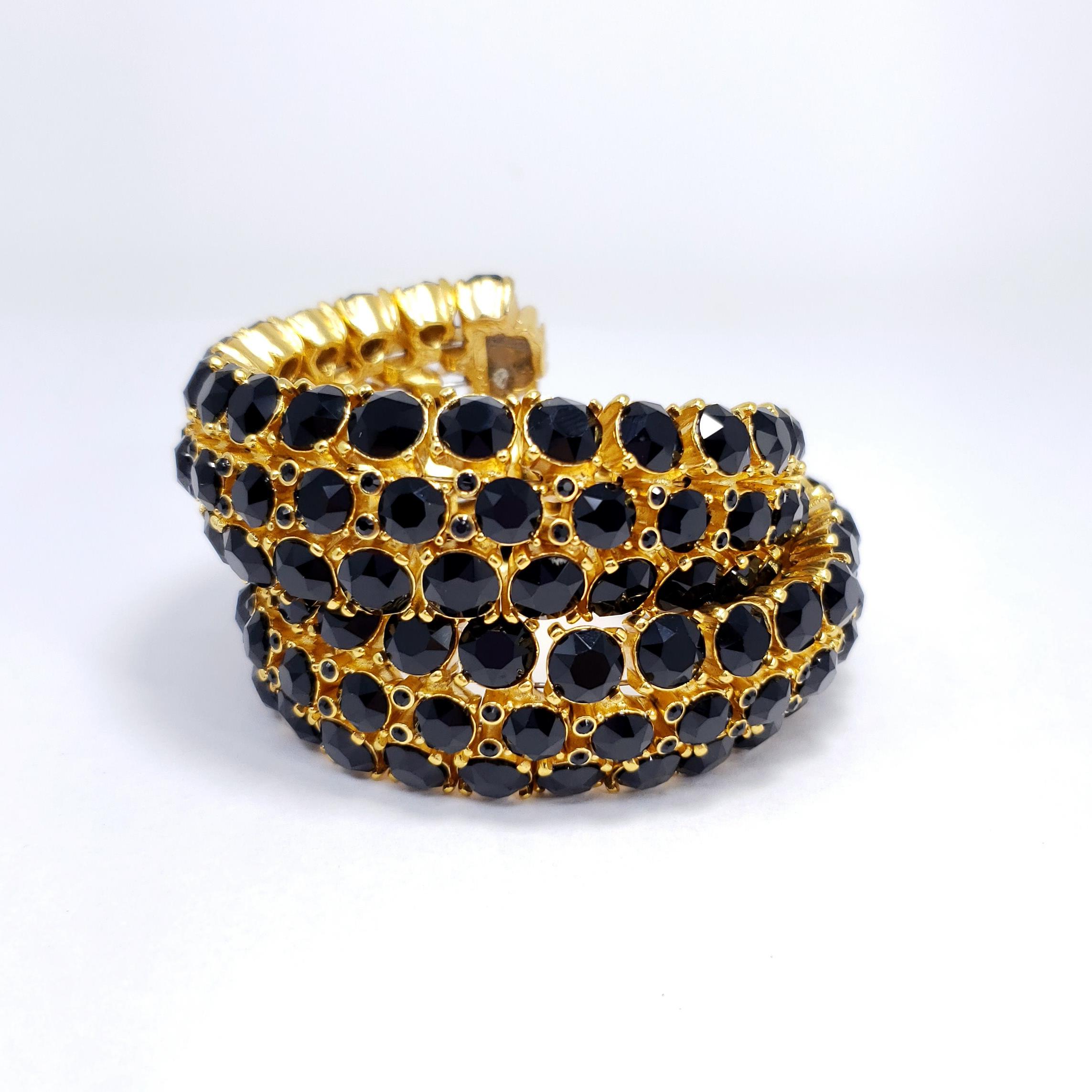 Golden Oscar de la Renta bracelet set with jet-black Swarovski crystals.

Gold plated. Wrap / bangle style. Wire-set.

Hallmarks: Oscar de la Renta, Made in USA