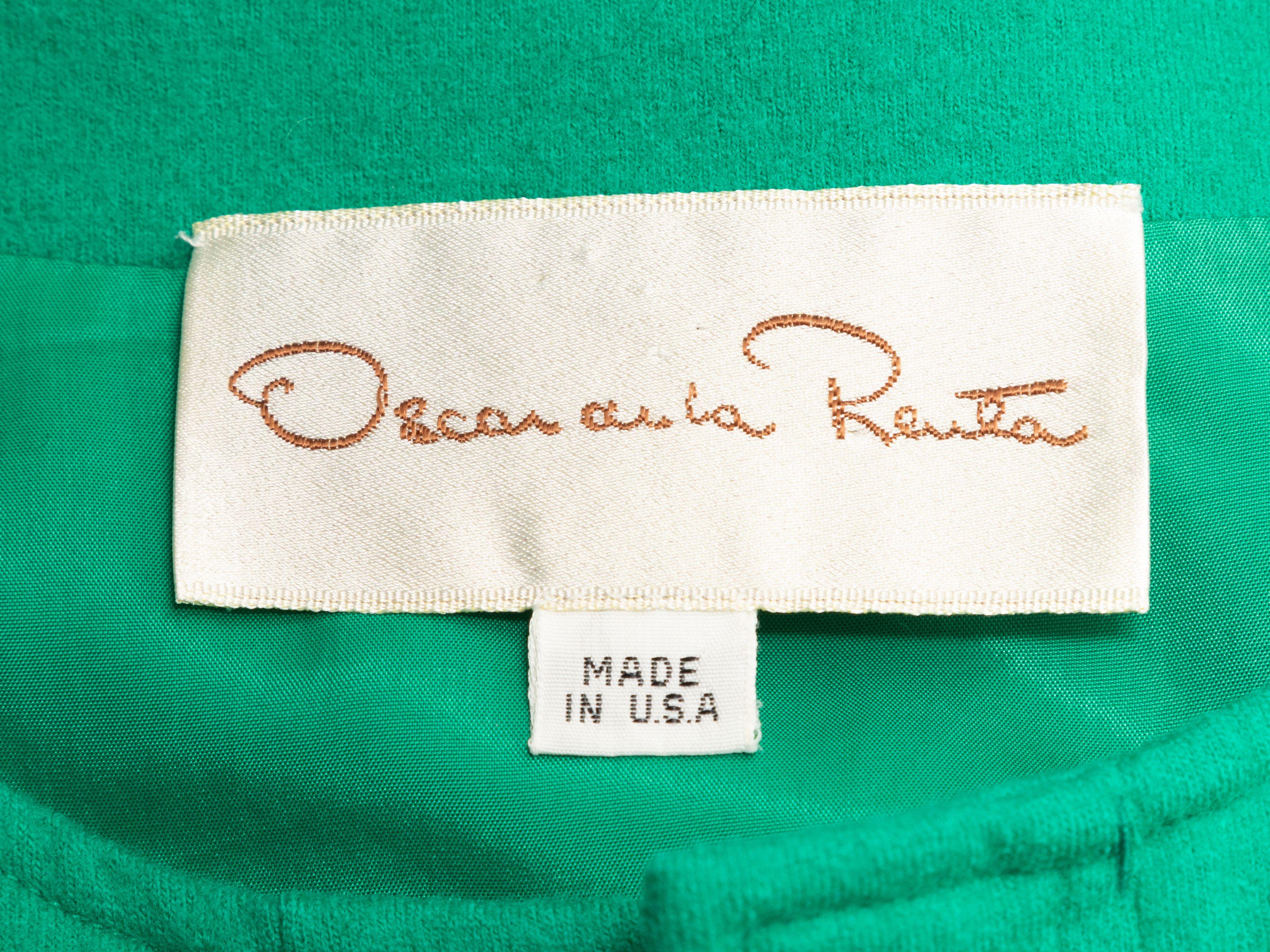 Product Details: Vintage green and black color block dress by Oscar de la Renta. Crew neck. Long sleeves. Button closures at center front. 28