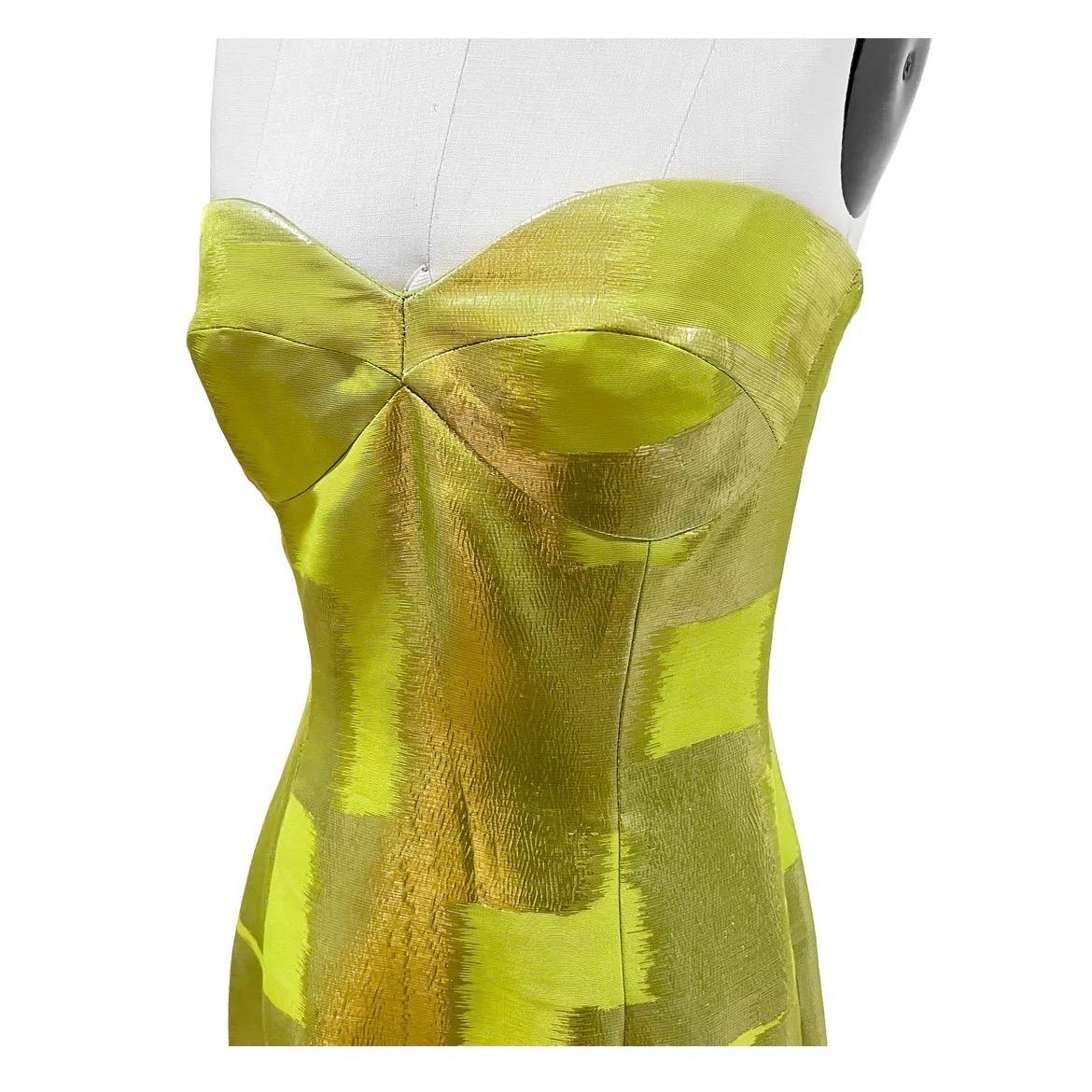 Green Strapless Vintage Gown by Oscar de la Renta
Green
Silver square pattern detail
Strapless
Dress has shorter curved cut out in front with longer back detail
Back of dress has ruched detail
Back zip closure
Heart shaped neckline 
Dress has corset