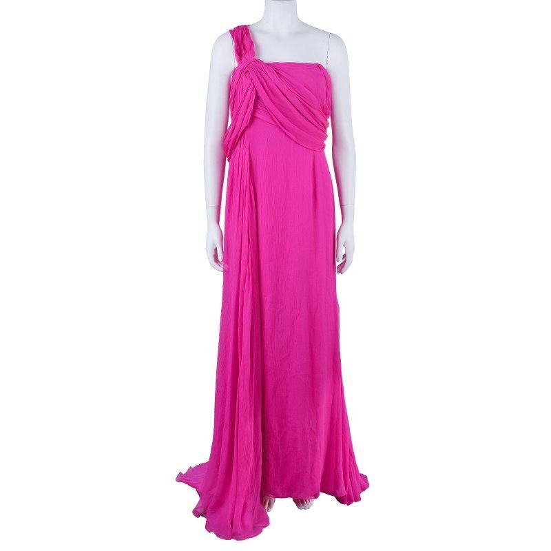 This fairy tale draped gown in a hot pink shade from Oscar de la Renta is a breathtaking one! This one-shoulder dress features a pleated shoulder strap falling at the back creating a unique style. The pleated bust drape highlight and a side fall add
