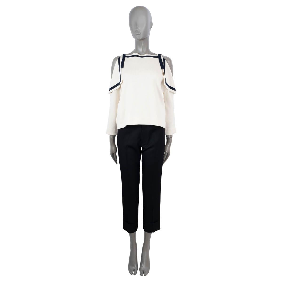 100% authentic Oscar de la Renta cold shoulder marine knit top in off-white and navy blue silk (59%) and cotton (41%). Features self-tie mesh at the shoulder and 3/4 sleeves. Unlined. Has been worn and is in excellent condition.

Measurements
Tag