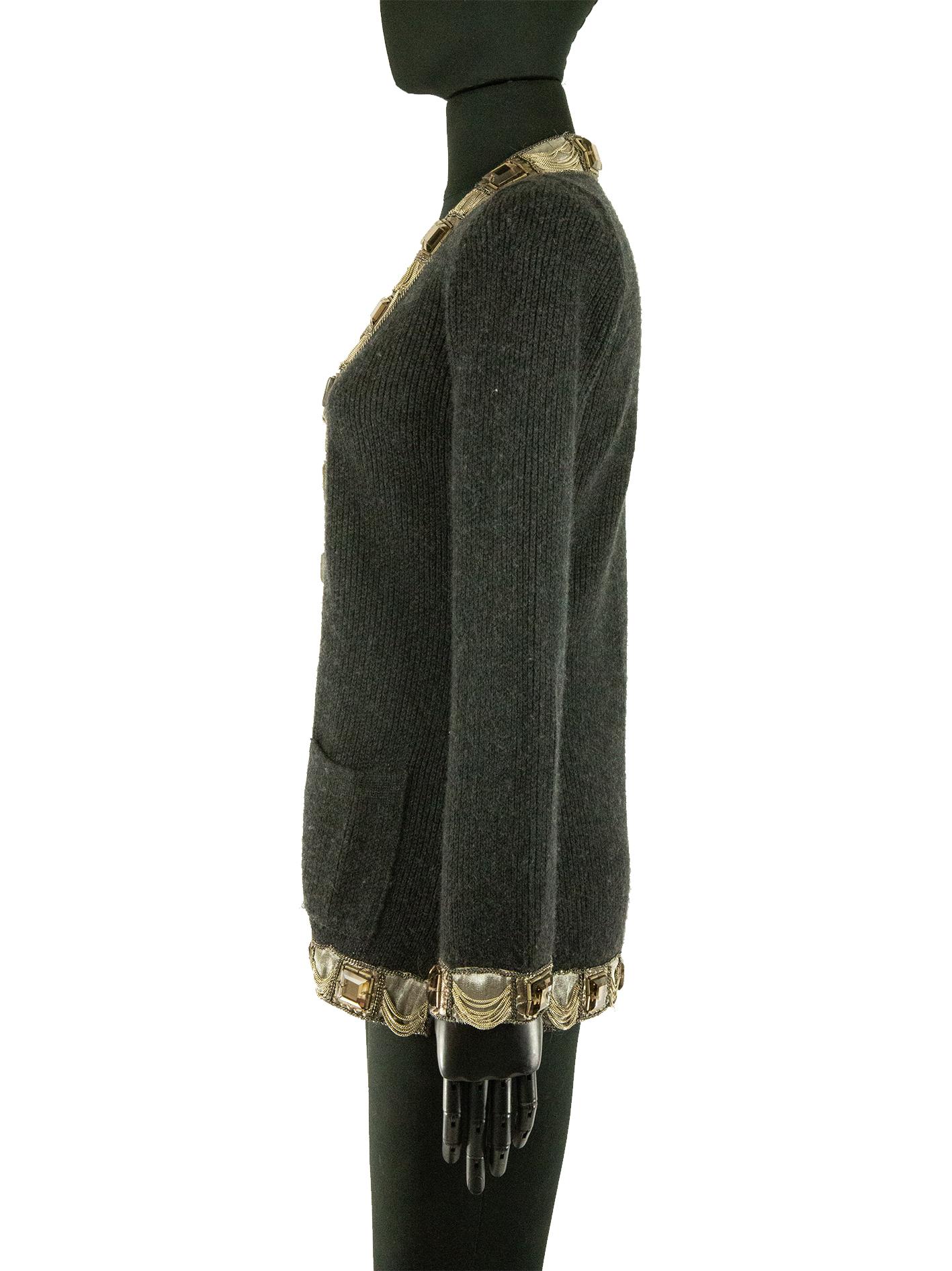 A deep grey long cashmere cardigan by Oscar De La Renta. This cardigan features unique embroidery throughout. Wrapping around the hem, through to the front of the cardigan and finally around the collar and separately around the cuffs; there’s