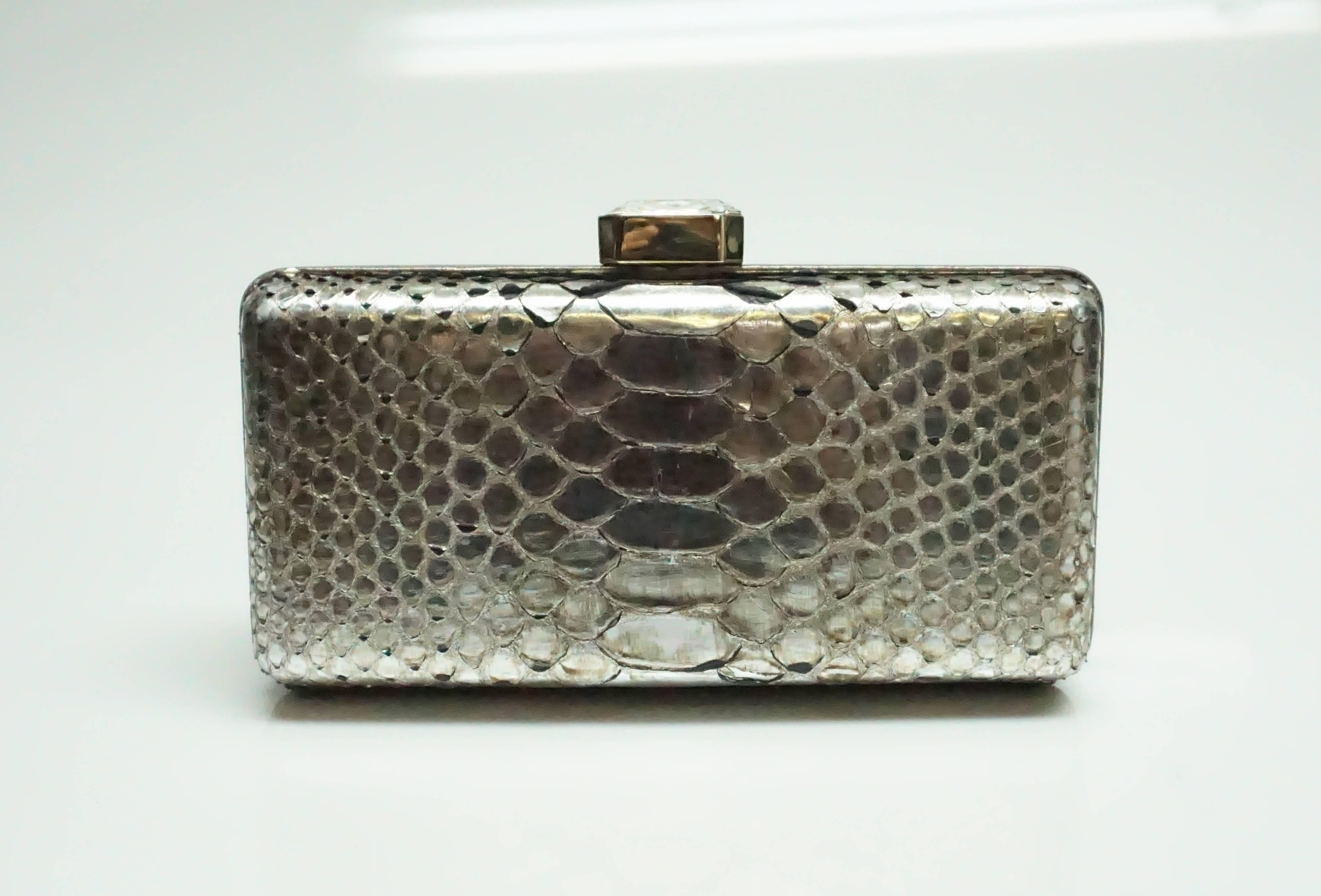 Oscar De La Renta Metallic Python Box Clutch  This beautiful piece is in good condition with some of the python skin a bit lifted. The entire outside of the clutch is made up of python skin and a leather trim. The inside is lined with silk. The
