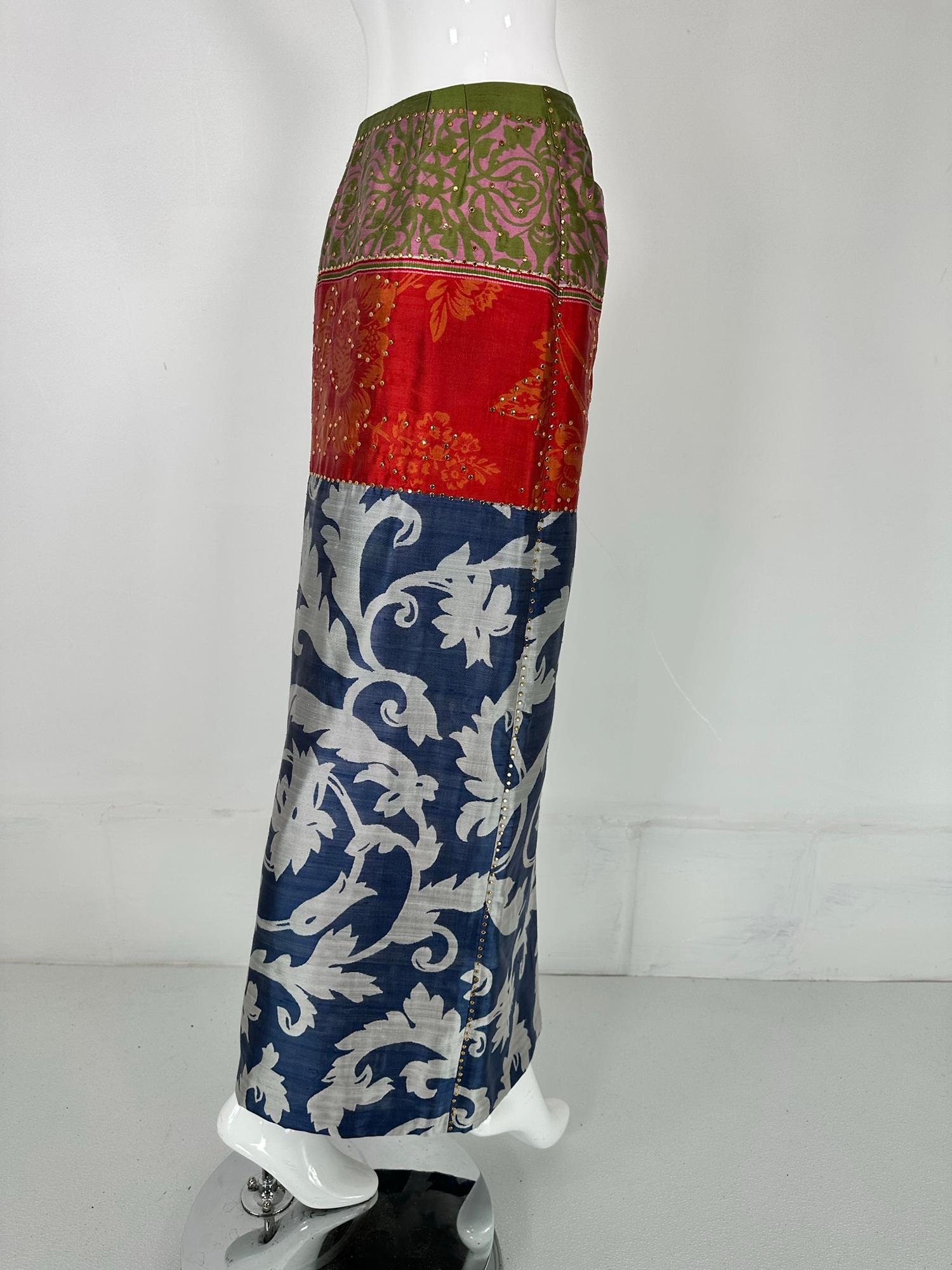 Oscar de la Renta mix print silk jean style maxi skirt with small gold studs. A beautiful mix of eye catching prints done in silk. The skirt closes at the waist center front with a fly zipper, two curved hip front pockets & a deep front hem vent.