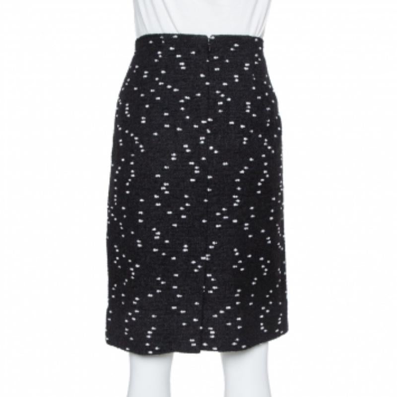 Oscar de la Renta's short skirt can last you seasons after seasons and can be styled in multiple ways. The creation is made from tweed and features a speckled pattern. Style it with a satin shirt and pumps for a chic appeal.