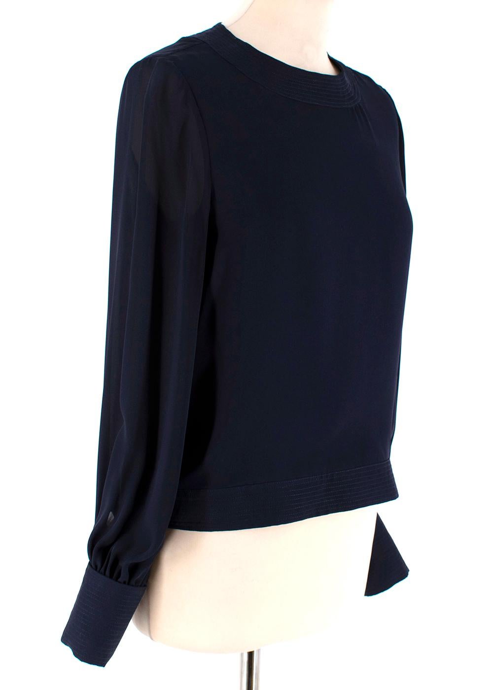 Oscar de la Renta Navy Blue Blouse with Large Rose Button Cuffs

- Navy Blue 
- Round neck 
- Cuffed Sleeves 
- White Rose button detail on cuffs 
- Bow detail on lower back 
- Lightweight 

Materials:
- 100% Silk
- Dry Clean only 

Made in USA