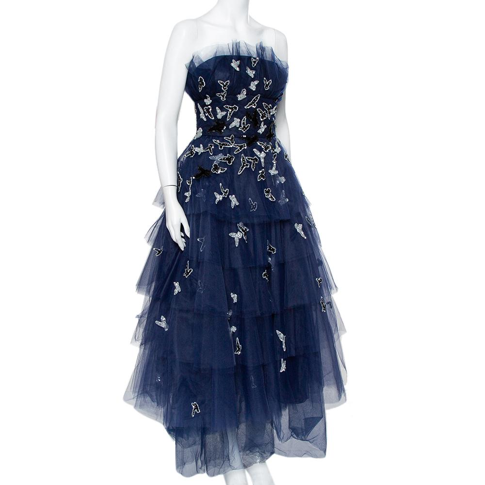 Oscar de la Renta's idea of femininity and modern approach to silhouettes are evident in this navy blue-hued midi dress. Featuring a beautiful tulle body, the embroidered tiered dress offers a comfortable fit and a beautiful impact.

Includes: