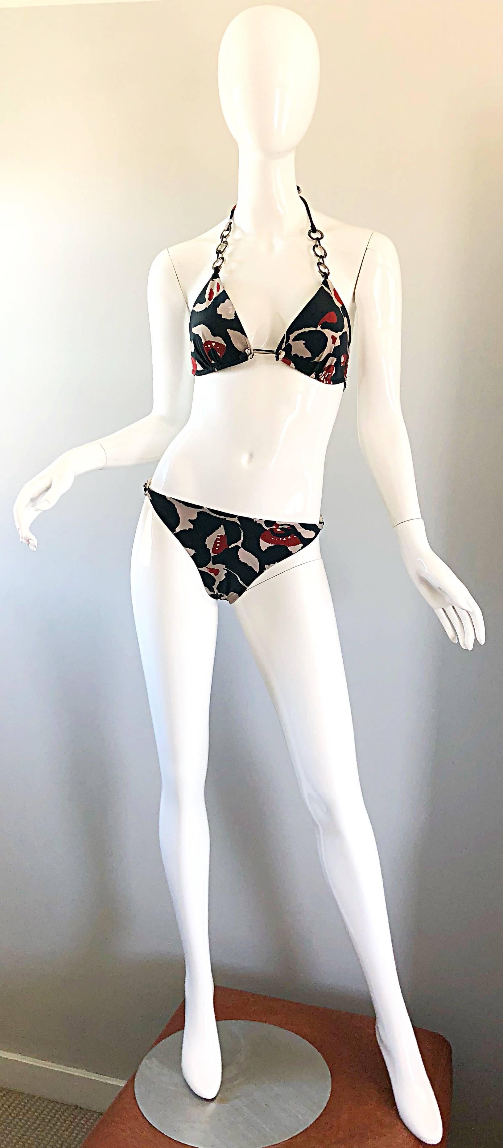 Sexy brand new with original store tags OSCAR DE LA RENTA Size Large two piece batik print bikini! Features a chic batik print in war colors of red, beige and black throughout. Black and silver chain links on the halter straps, and at each hip.