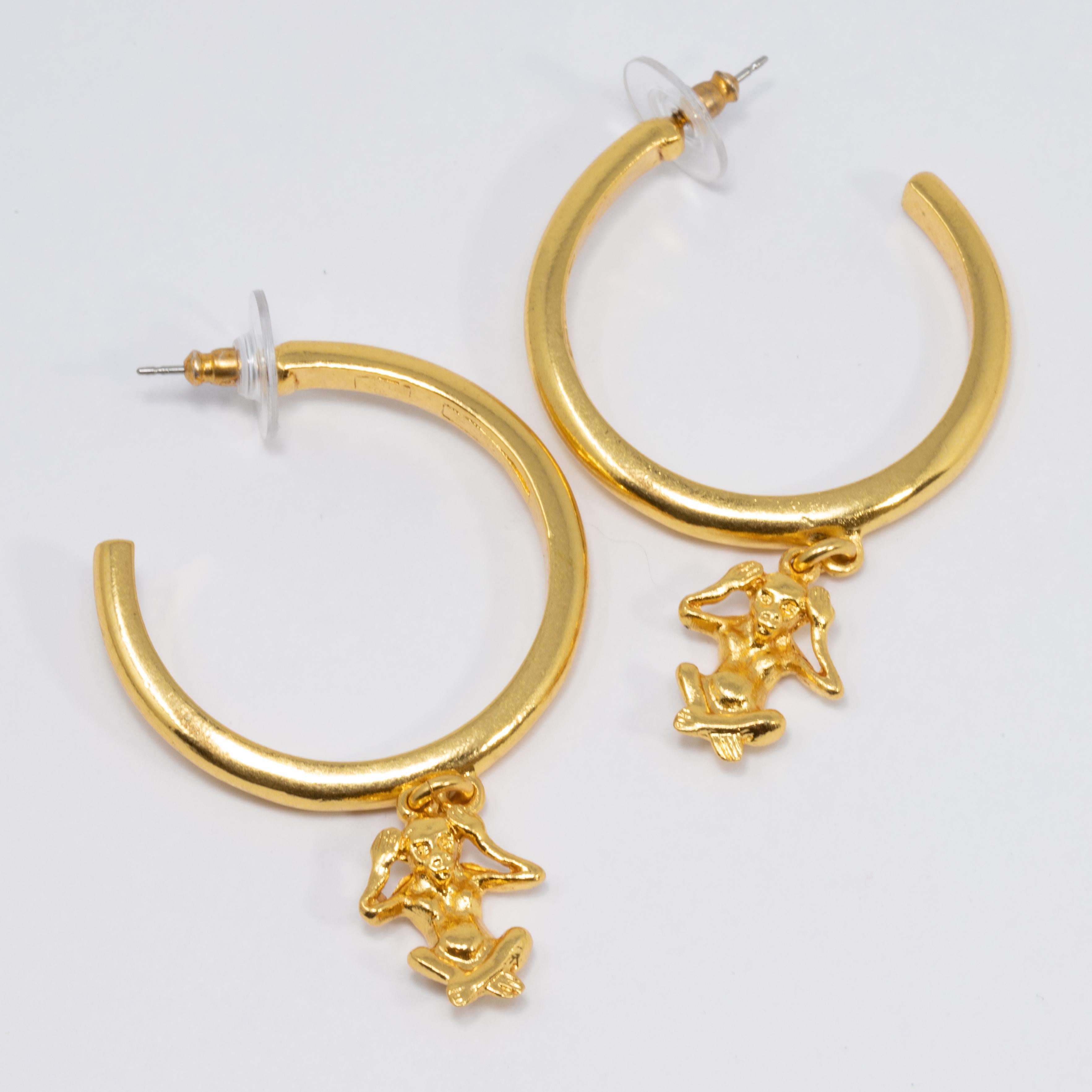 A bold and bright pair of open hoop earrings by Oscar de la Renta. Each earring features a dangling 