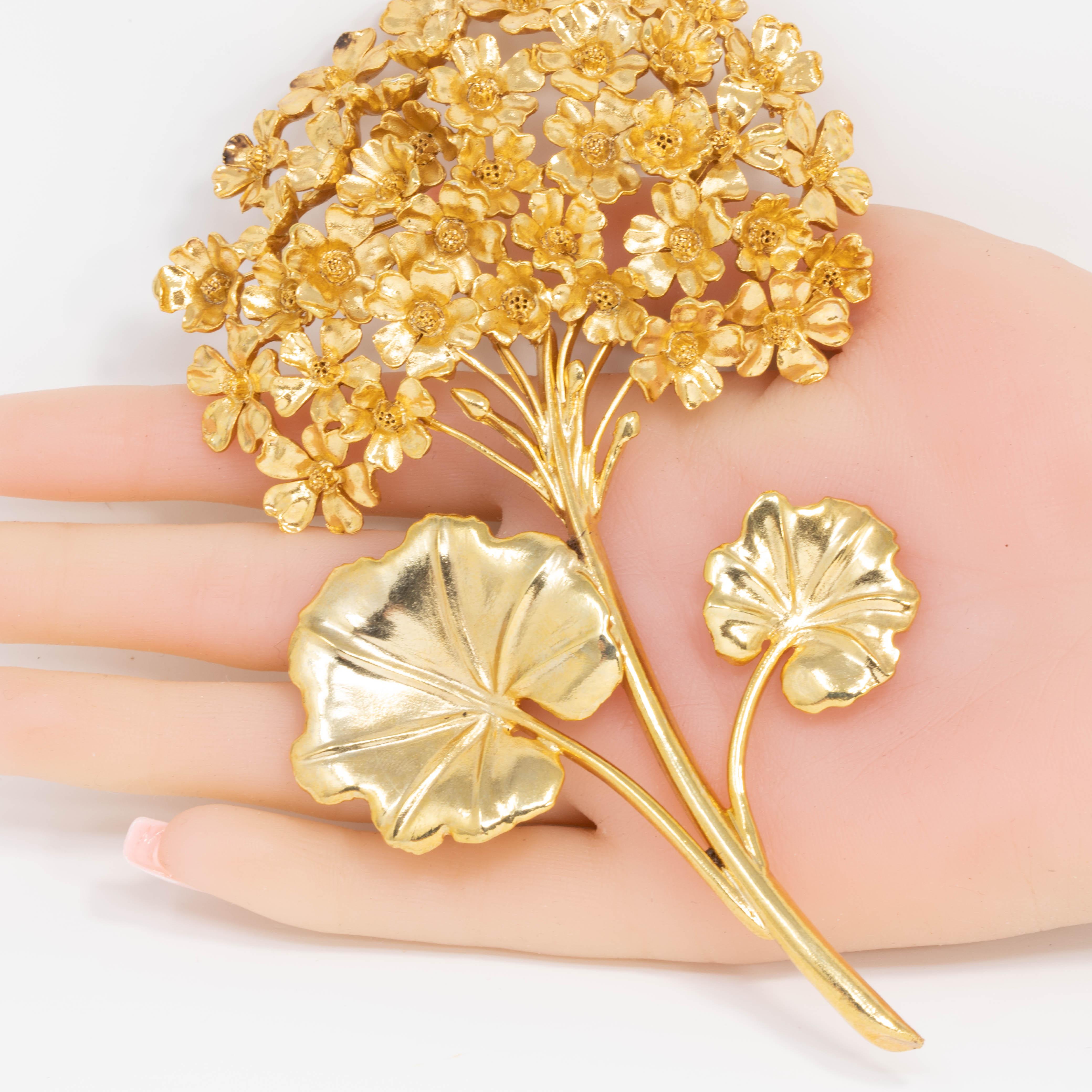 Crafted into a bouquet of gold-tone geranium flowers, this gleaming pin brooch will be an elegant finishing touch on any lapel.

22KT gold plated.

Tags, Marks, Hallmarks: Oscar de la Renta, Made in USA