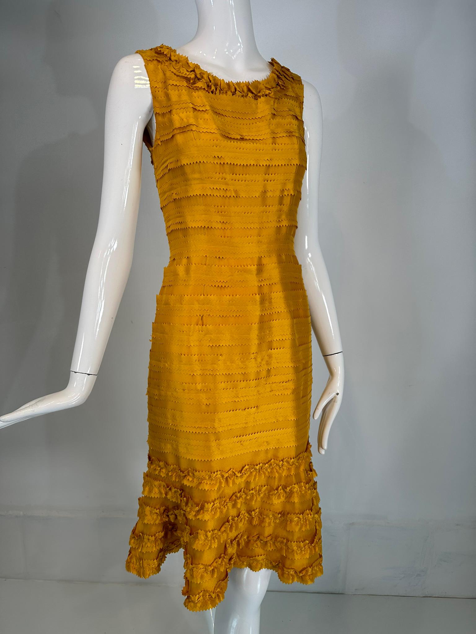 Oscar de la Renta Pre-Fall 2011 marigold silk pinked edge, ruffle neck sheath dress. The most gorgeous colour silk, perfect for any season, but especially fall. 
Sleeveless scoop neck dress has a ruffle neckline. The bodice is fitted with a seamed