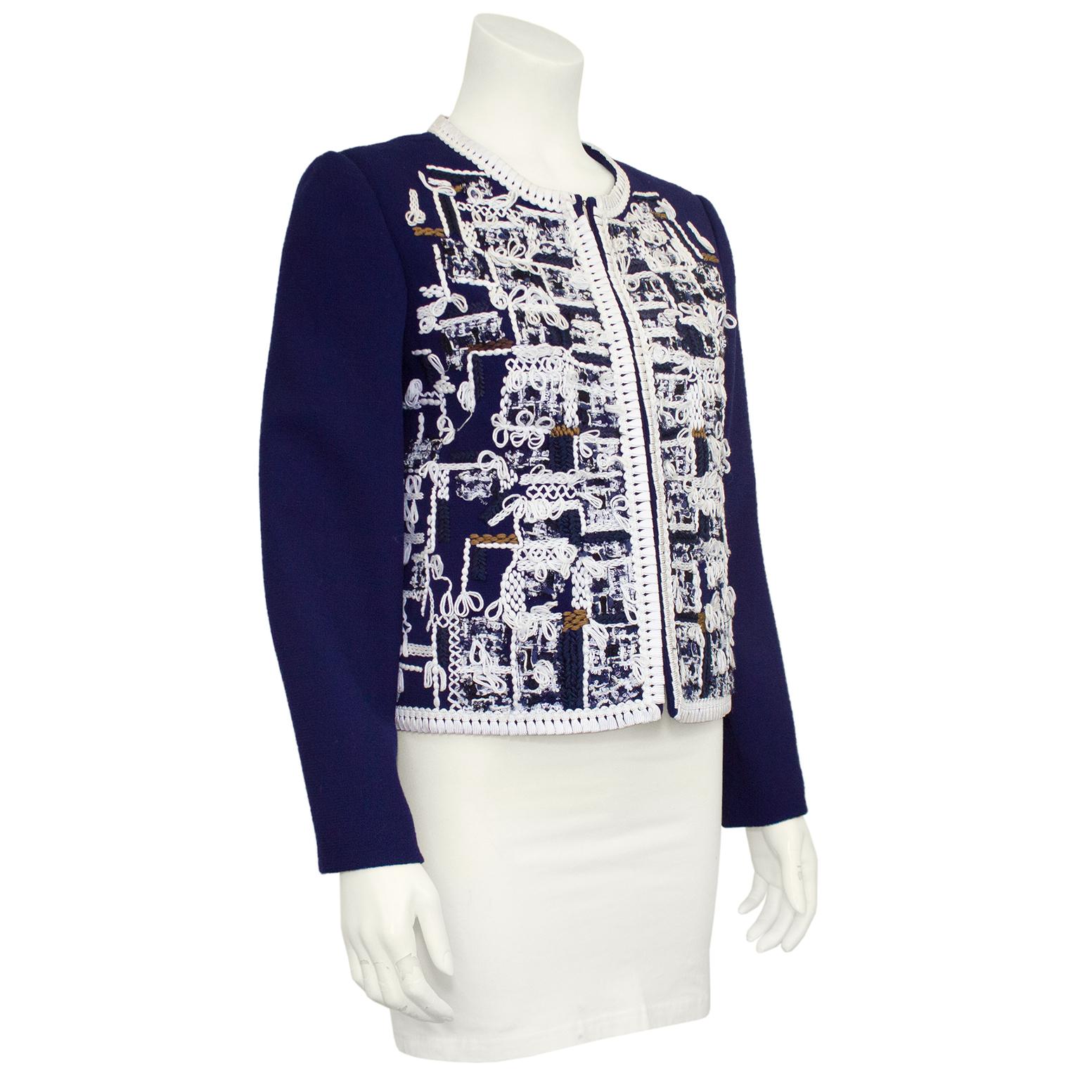 Oscar De La Renta Navy jacket from the 2011 pre fall collection. The irregular loopy embroidery covers the front and back sides of the bomber style jacket in white thread with touches of navy, blue and brown. Whipstitched along the crew neckline,