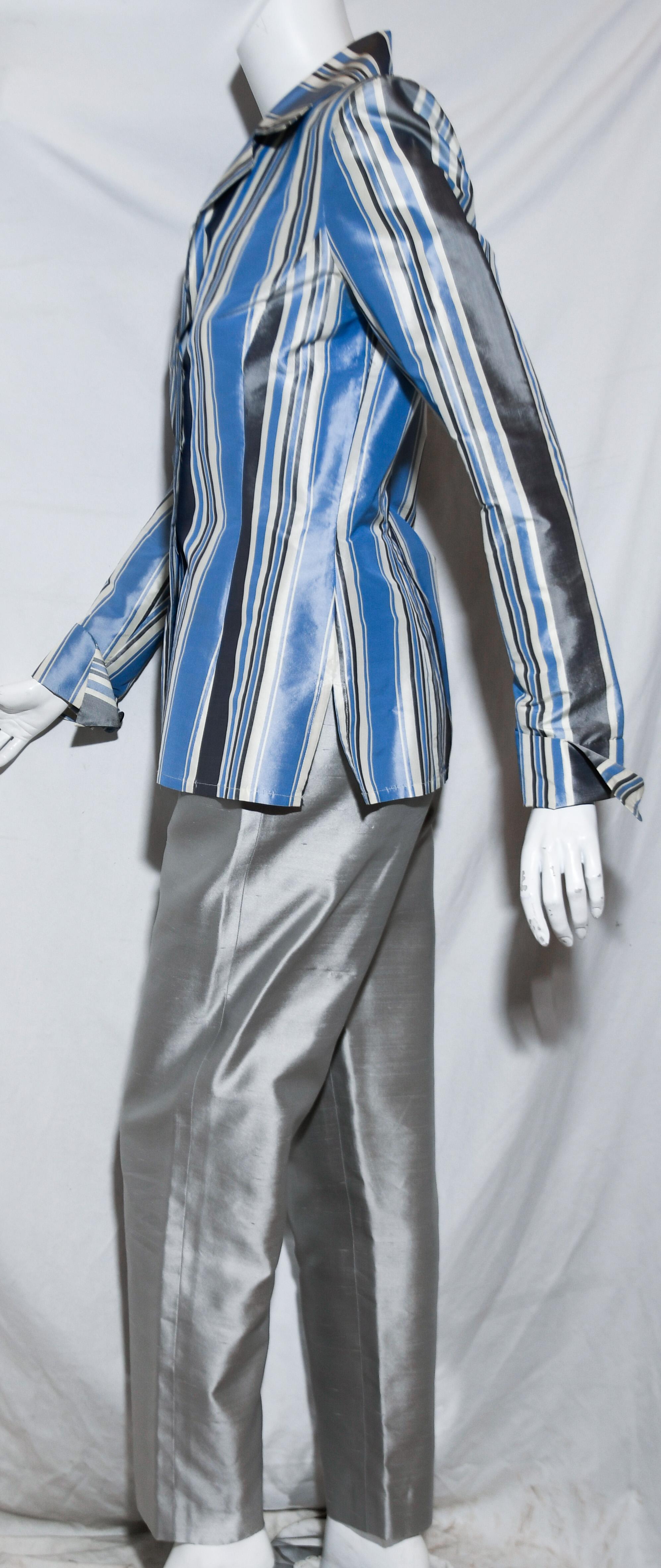 Oscar de la Renta raw silk 2 piece pant suit includes a multi color striped jacket in tones of blue, ivory and grey.  The slacks are solid grey.  This shirt style jacket has turn up cuffs, shirt collar and 3 buttons for closure.   The jacket is not