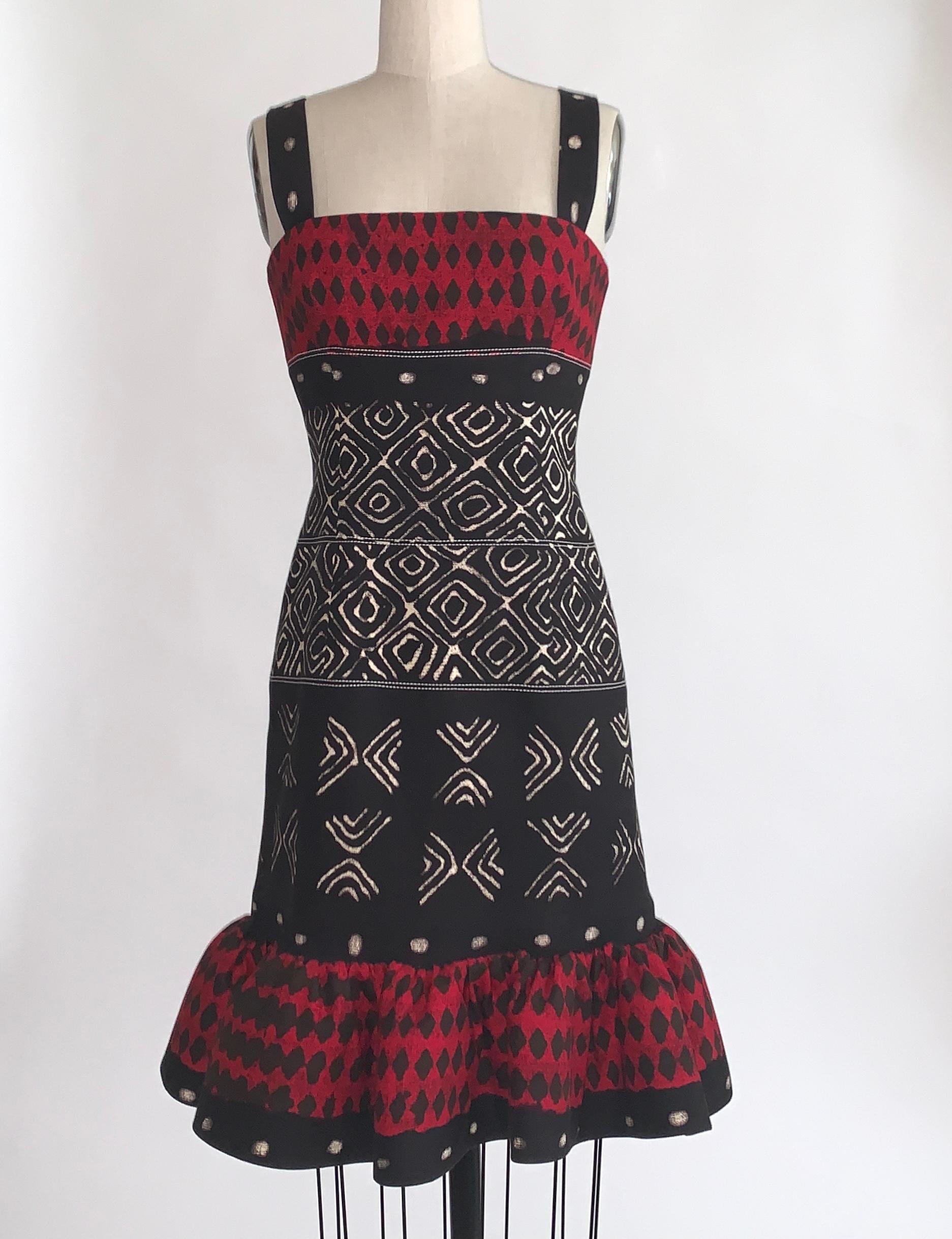 Oscar de la Renta red, black and ivory tribal ikat batik print sleeveless pencil dress with flared bottom. A thin stiff mesh ring at skirt bottom and light boning at side bust  and create dramatic shape. Back zip and hook and eye.

98% cotton, 2%