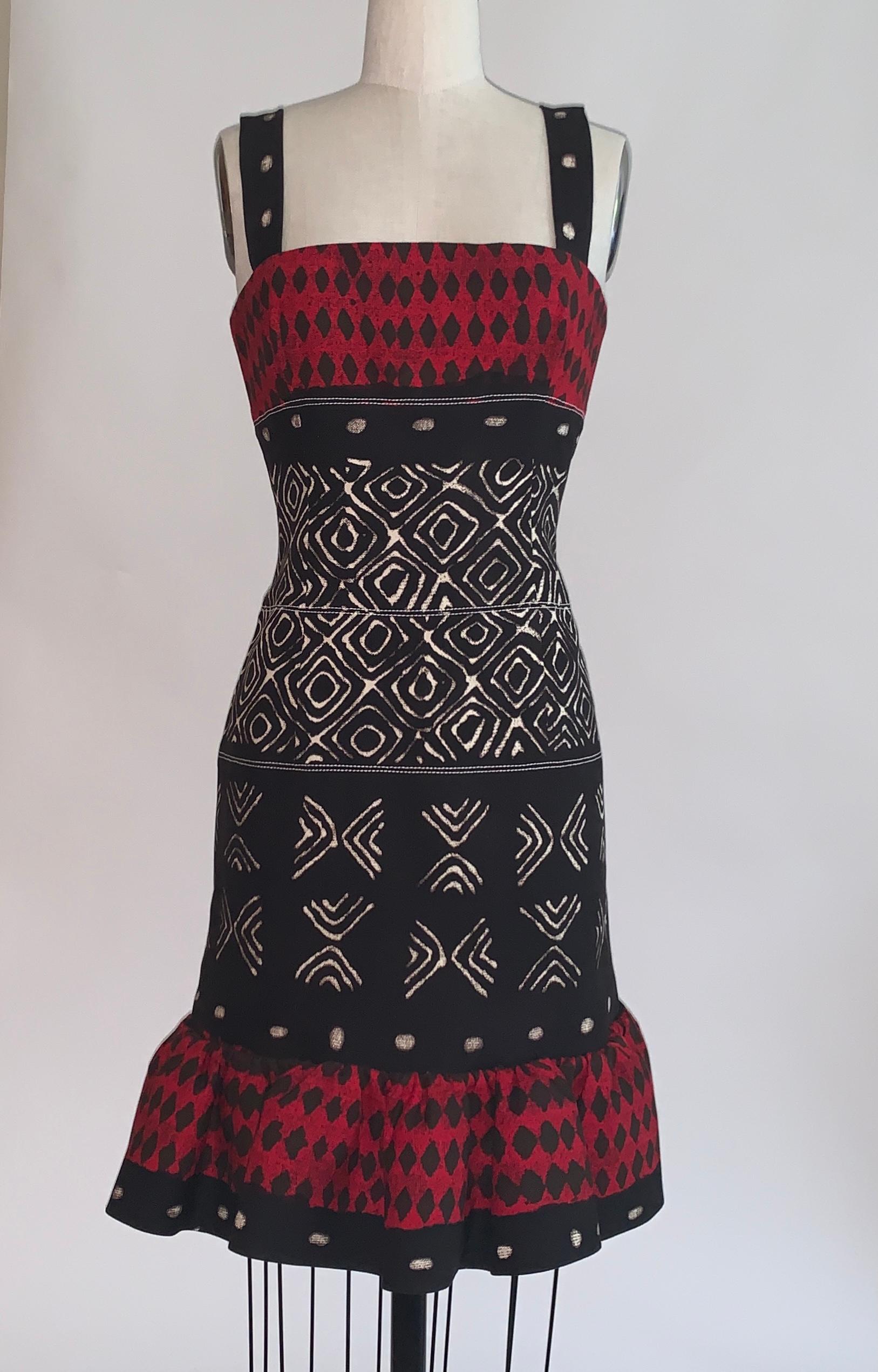 Oscar de la Renta red, black and ivory tribal ikat batik print sleeveless pencil dress with flared bottom. A thin stiff mesh ring at skirt bottom and light boning at side bust  and create dramatic shape. Back zip and hook and eye.

98% cotton, 2%