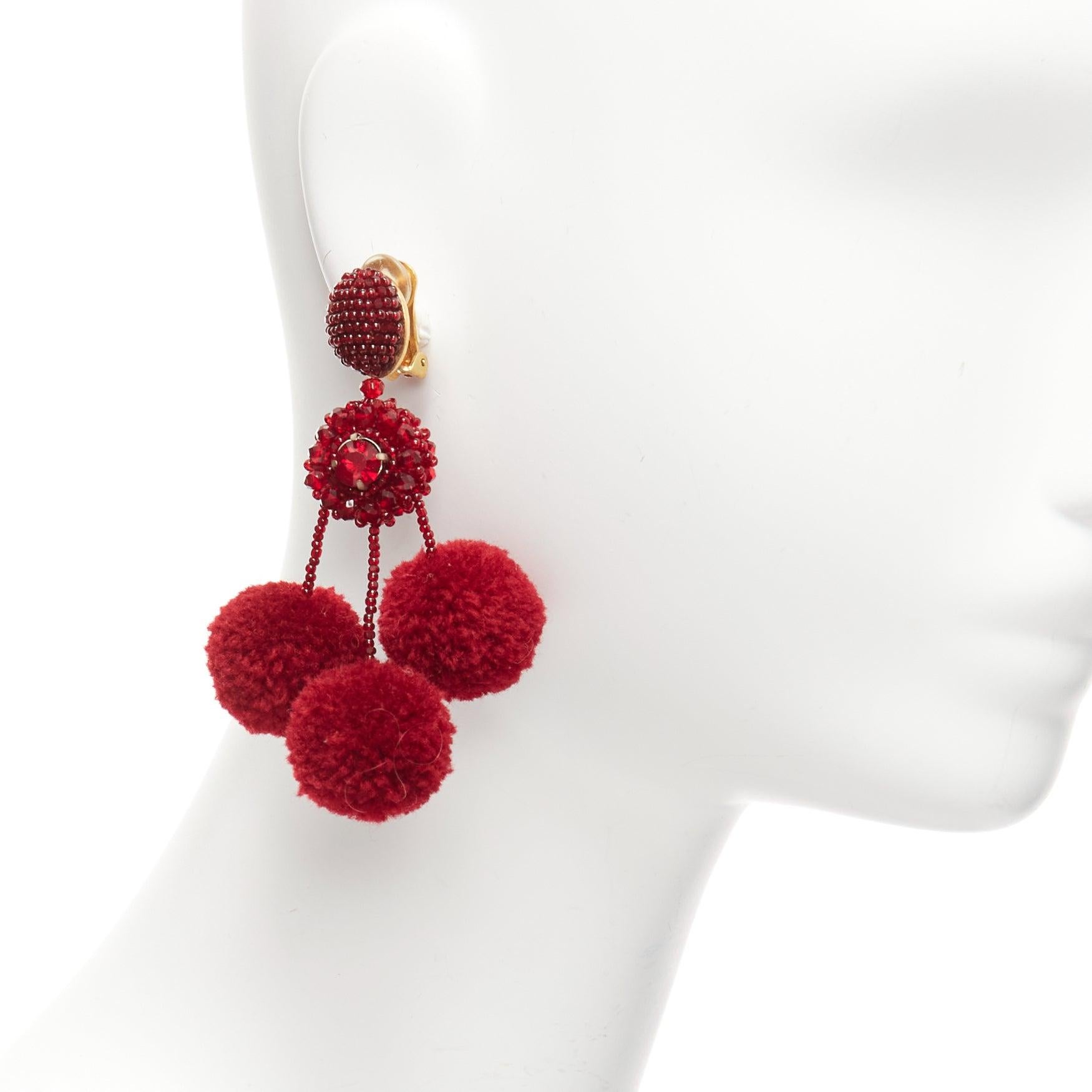 OSCAR DE LA RENTA dark red pompom beads embellished dangling clip on earrings pair
Reference: AAWC/A01048
Brand: Oscar de la Renta
Material: Fabric, Acrylic
Color: Red, Gold
Pattern: Solid
Closure: Clip On
Lining: Gold Metal
Made in:
