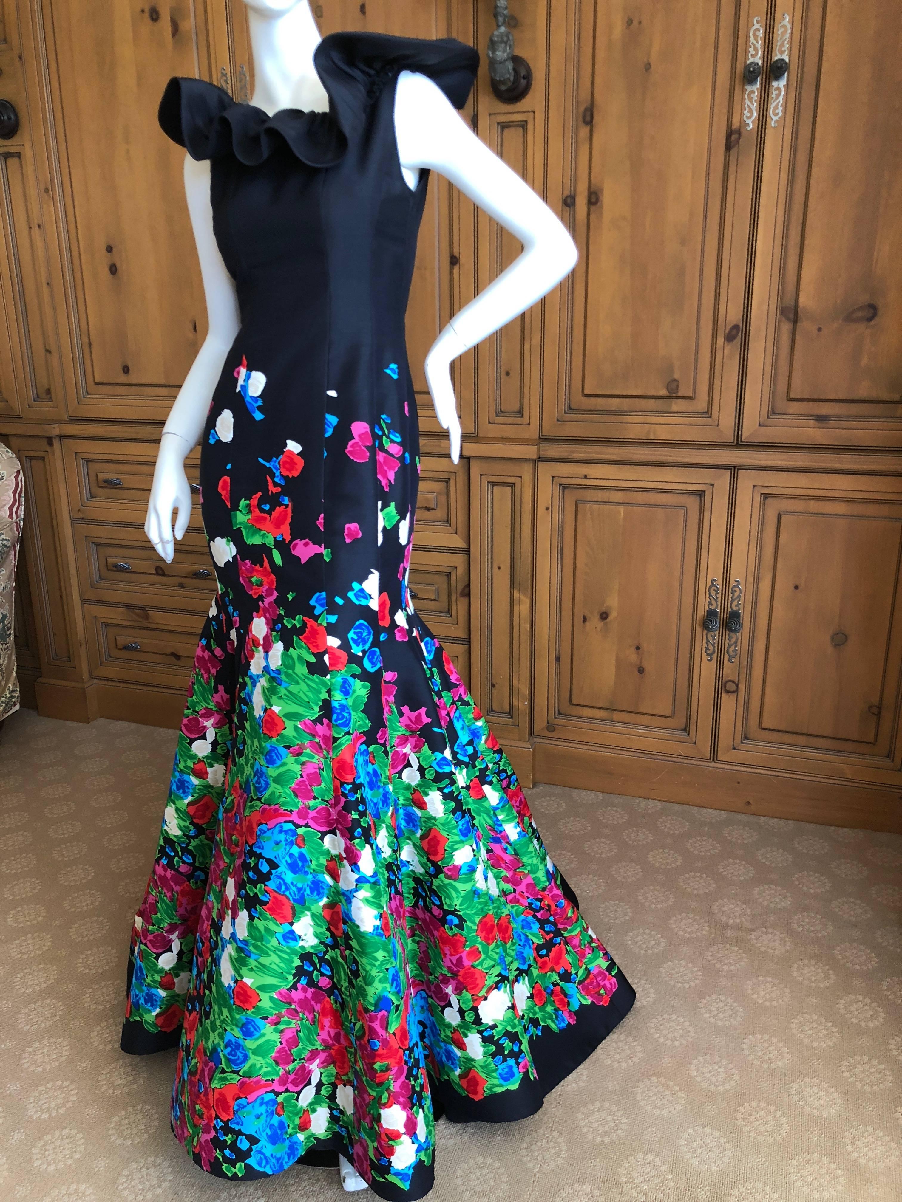 Oscar de la Renta Romantic Rose Floral Embellished Black SIlk Evening Dress.
This is such a pretty dress, the photos don't do it justice .
Ruffled collar , under layers of skirting and a flowing train.
Classic Oscar.
Size 2
Bust 34