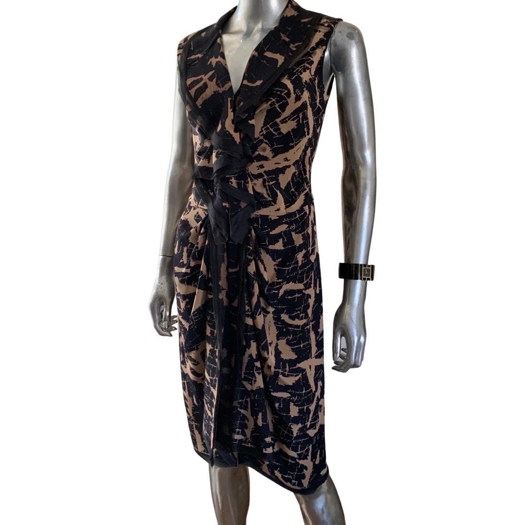 Such a chic dress from Oscar De La Renta 2010 runway collection. The dress is a sleeveless she’s in a beautiful black and brown abstract print the details on this dress are too numerous to list. The highlight is a silk organza raw edged double