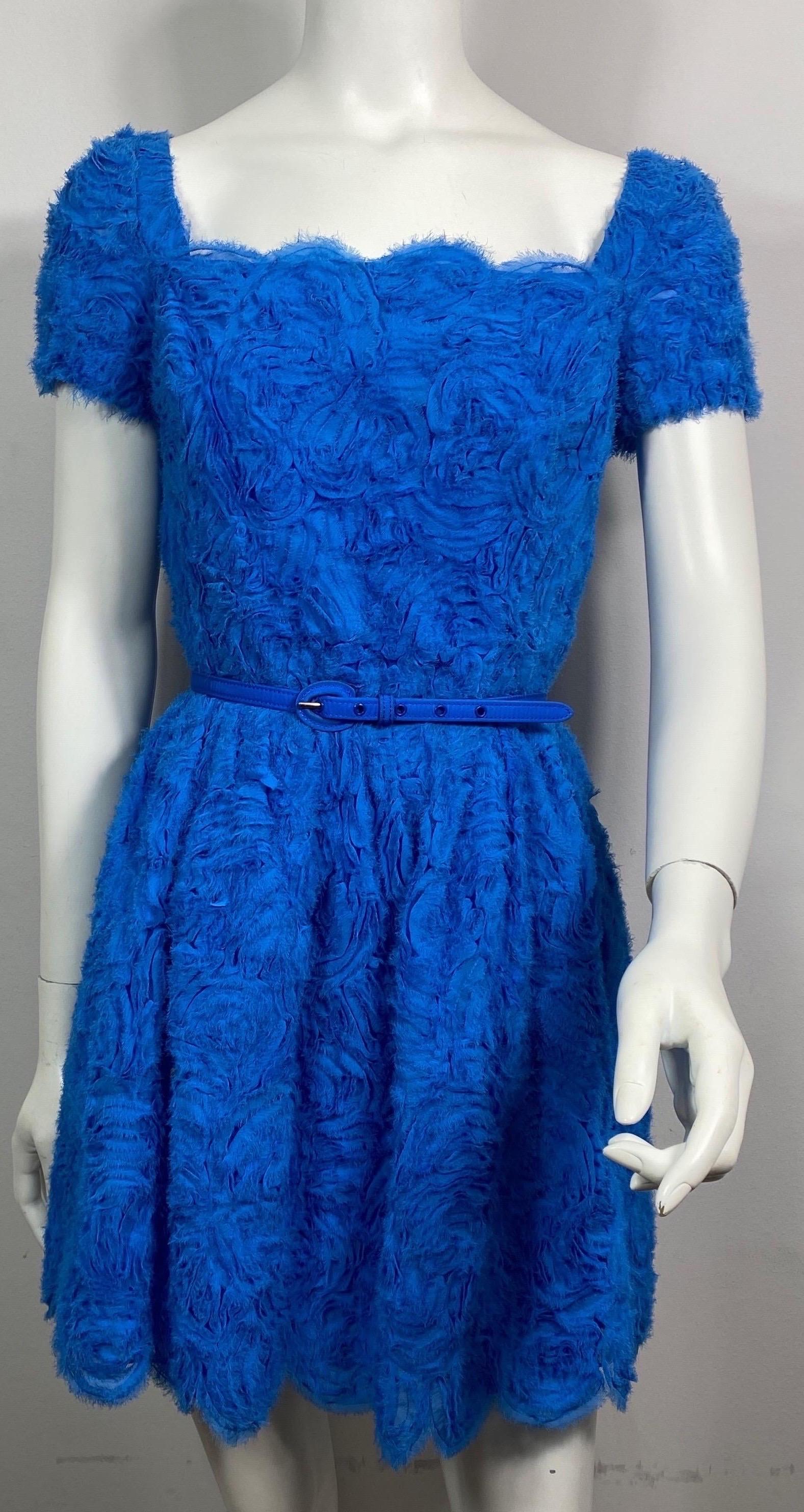 Oscar de La Renta Runway Resort 2013 Royal Blue Chiffon Rosette Embellished Dress-Size 4 This pacific royal blue somewhat mini dress is made of a fabric that is silk chiffon strips (with frayed edges) hand sewn as appliqué’s onto a mesh forming