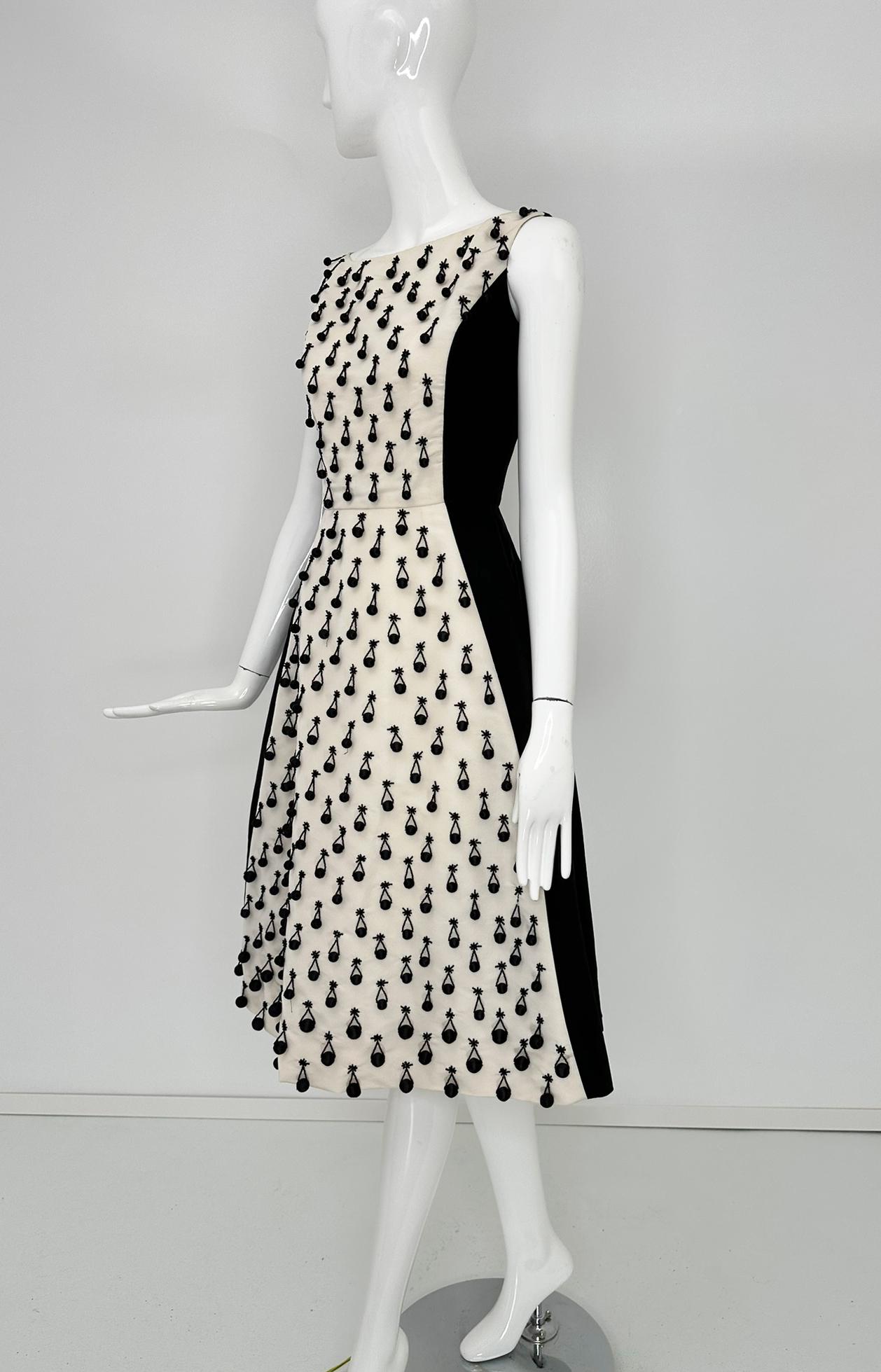 Oscar de la Renta S/S 2013 look 35, black & white silk twill beaded cocktail dress marked size 2.  Sleeveless bateau neckline dress with princess seams, seamed waist and a bell skirt. The bodice is fitted and the skirt is shaped like a bell. The