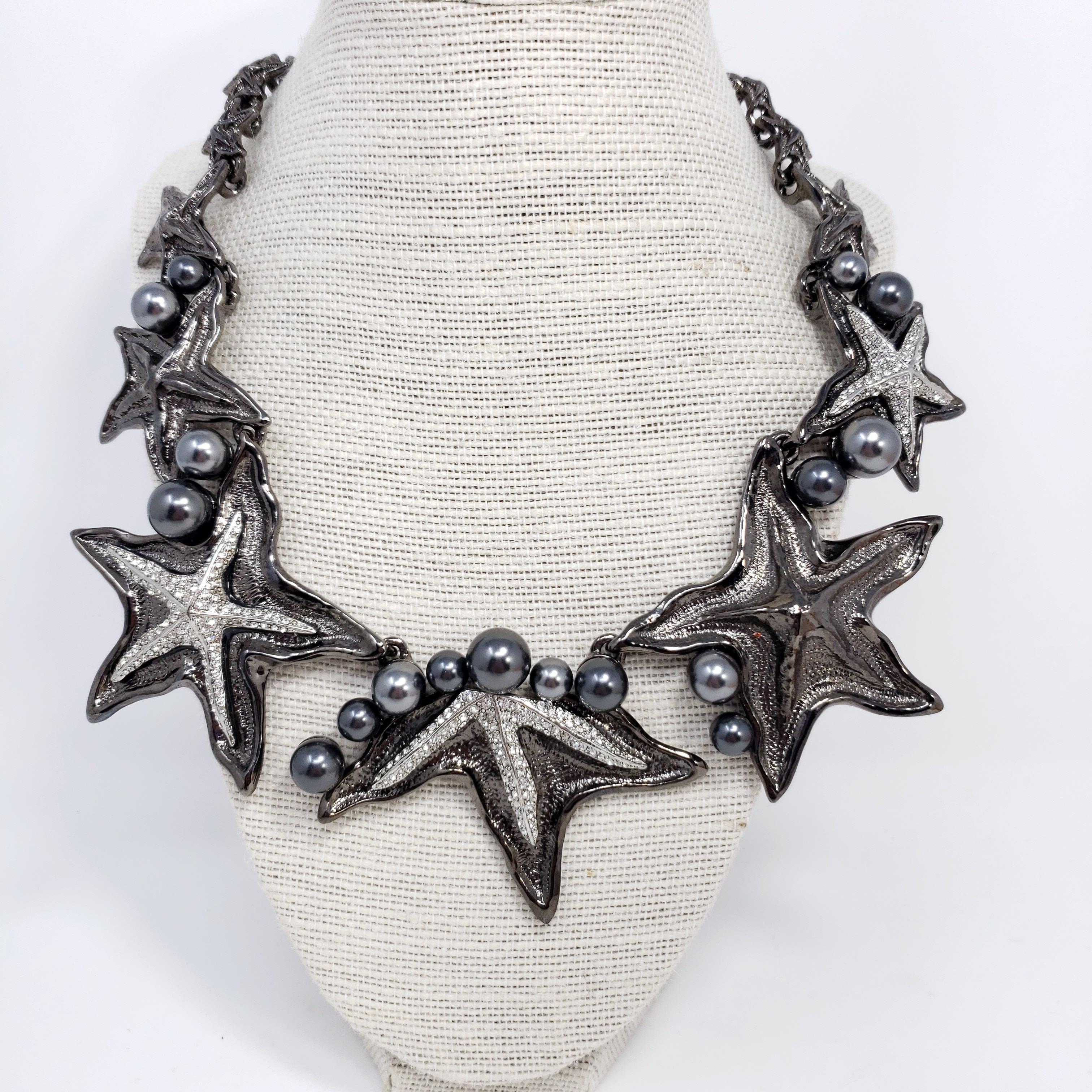 Inspired by marine life, Oscar de la Renta's collar link necklace is beautifully cast to resemble a collection of graduated starfish. This silver and dark gray gunmetal-tone piece is embellished with sparkling Swarovski pearls and crystals.