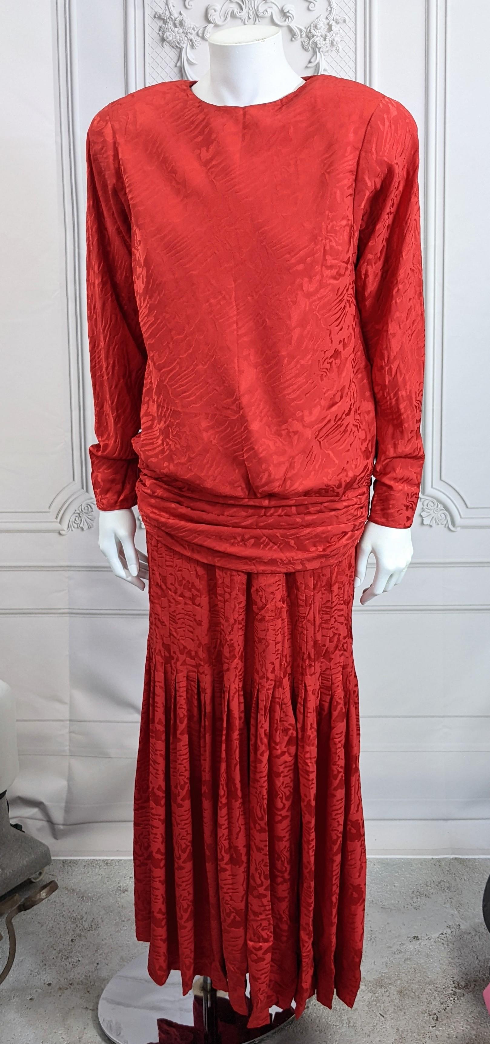 Elegant Oscar de la Renta 2 piece Silk Jacquard Evening Gown in vibrant red crepe de chine. Composed of a strong shouldered bias cut top which is bloused into a tight gathered hip band. The slim skirt has dozens of tucks which release into dramatic