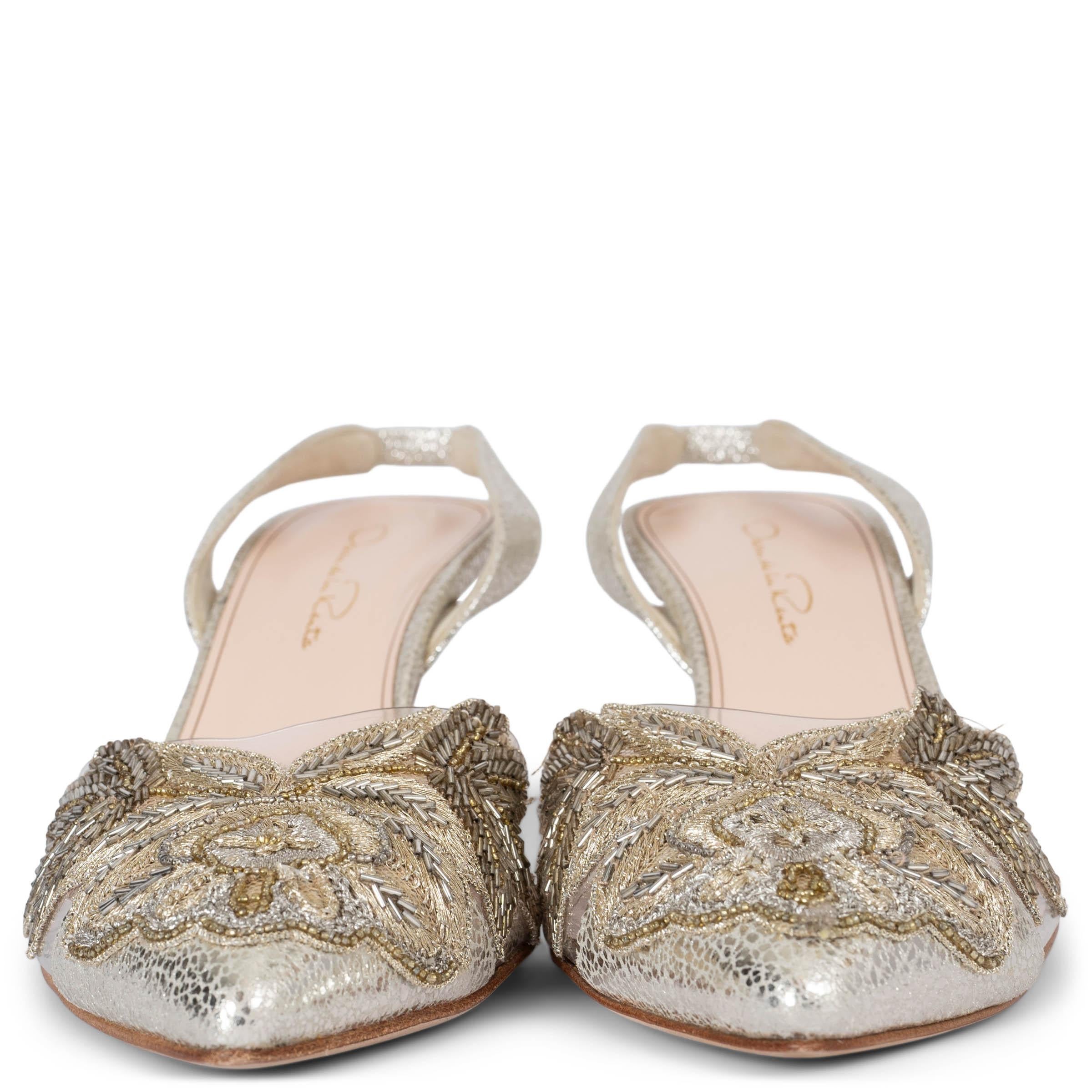 These 100% authentic Oscar de la Renta slingbacks are a luxurious statement piece, featuring beaded metallic brocade embellishments on a transparent PVC upper. The design includes cracked silver leather accents, a metallic gold-tone heel, and a