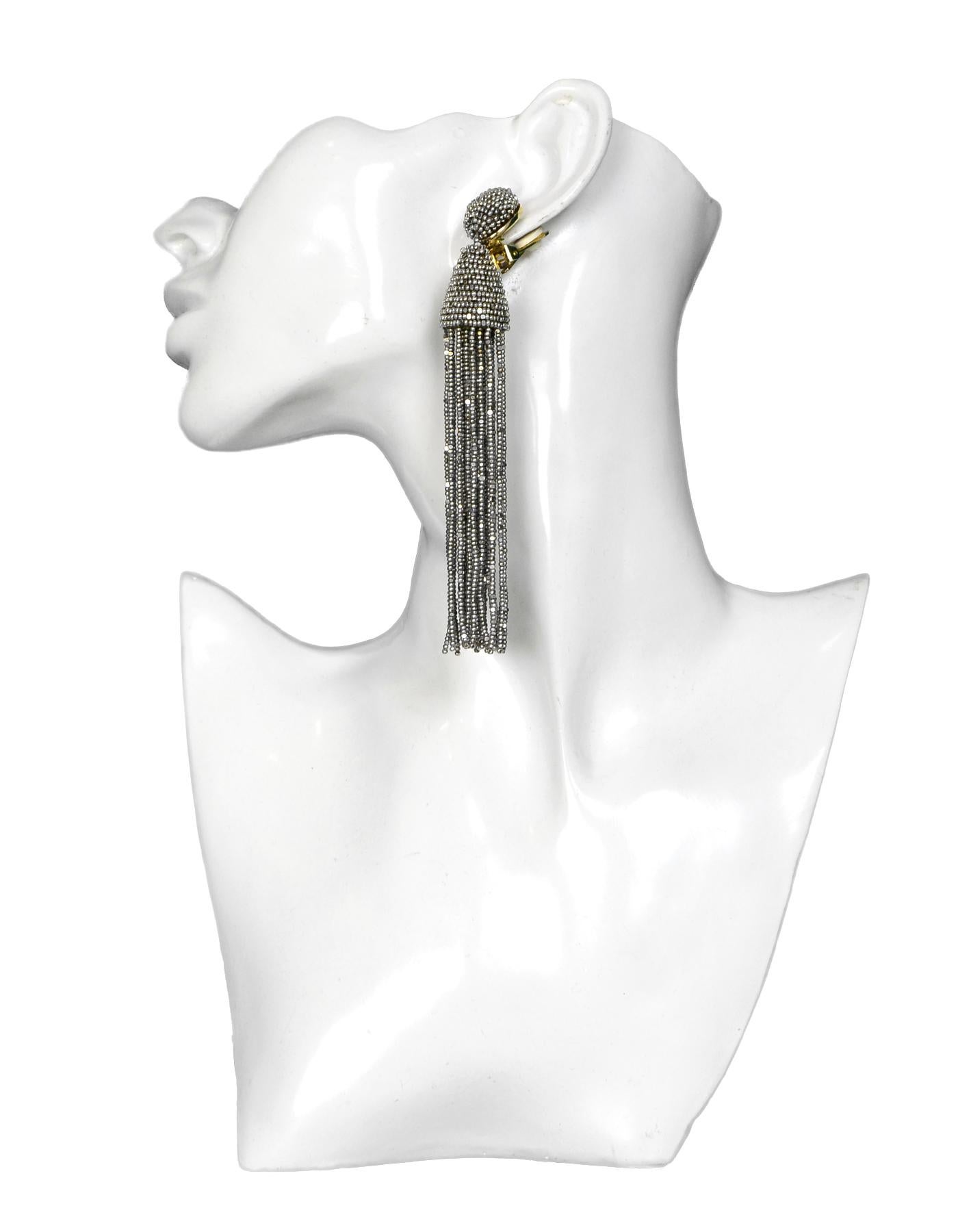 Oscar De La Renta Silvertone Tassel Clip-On Dangle Earrings

Color: Silvertone, goldtone
Materials: Silvertone metal
Hallmarks:   