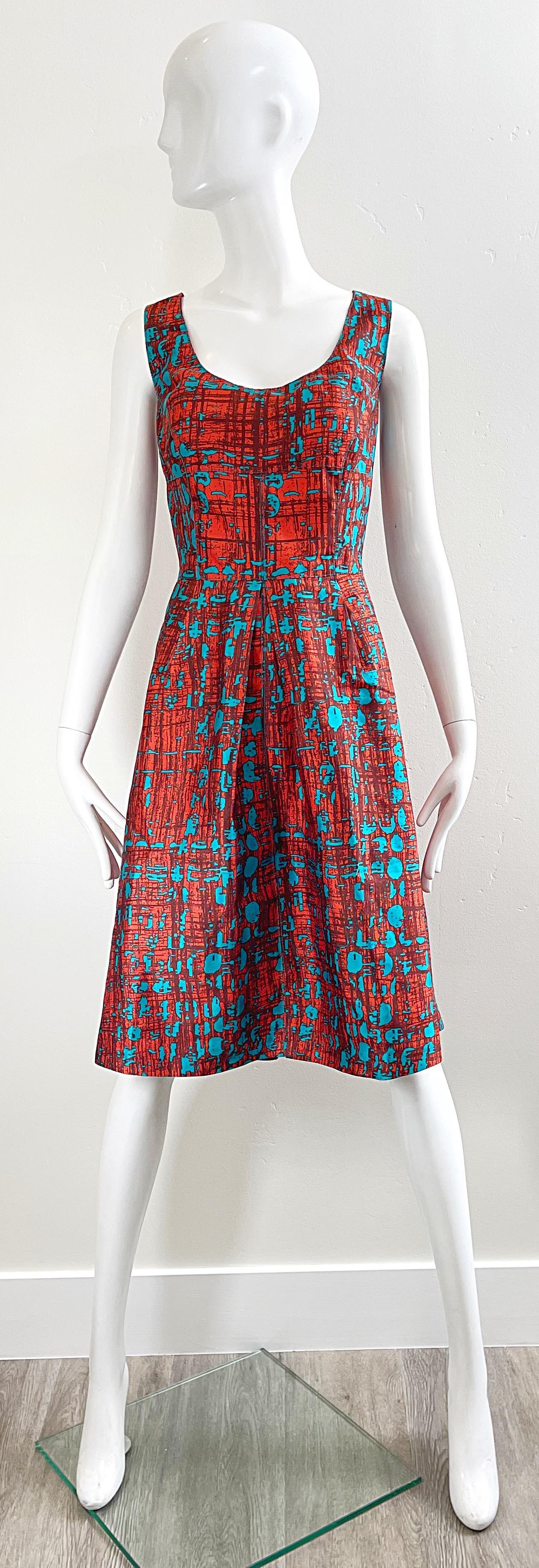 Chic early 2000s vintage OSCAR DE LA RENTA Size 14 orange and turquoise blue silk fit n’ flare cocktail dress ! Features a flattering abstract print. Tailored bodice with a forgiving full skirt. A crinoline could be worn under for an even fuller