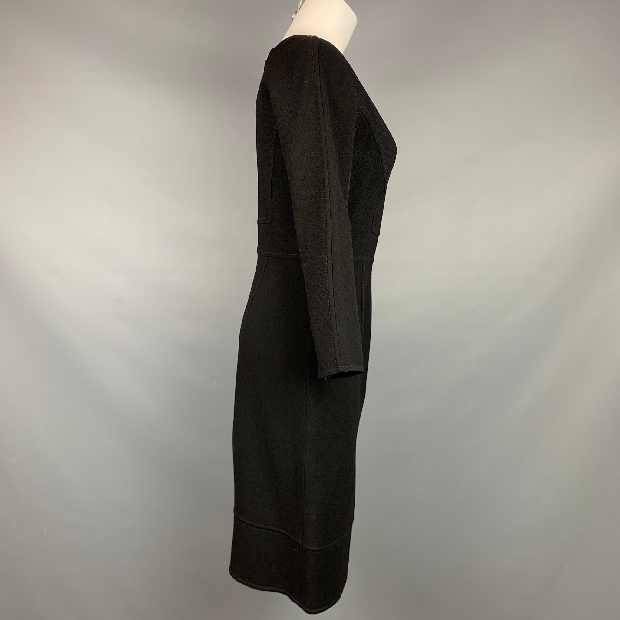 OSCAR DE LA RENTA dress comes in a black crepe wool featuring a fitted style, a-line, top stitching, and a back zip up closure. Made in Italy.

Very Good Pre-Owned Condition.
Marked: 4

Measurements:

Shoulder: 17 in.
Bust: 32 in.
Waist: 28 in.
Hip: