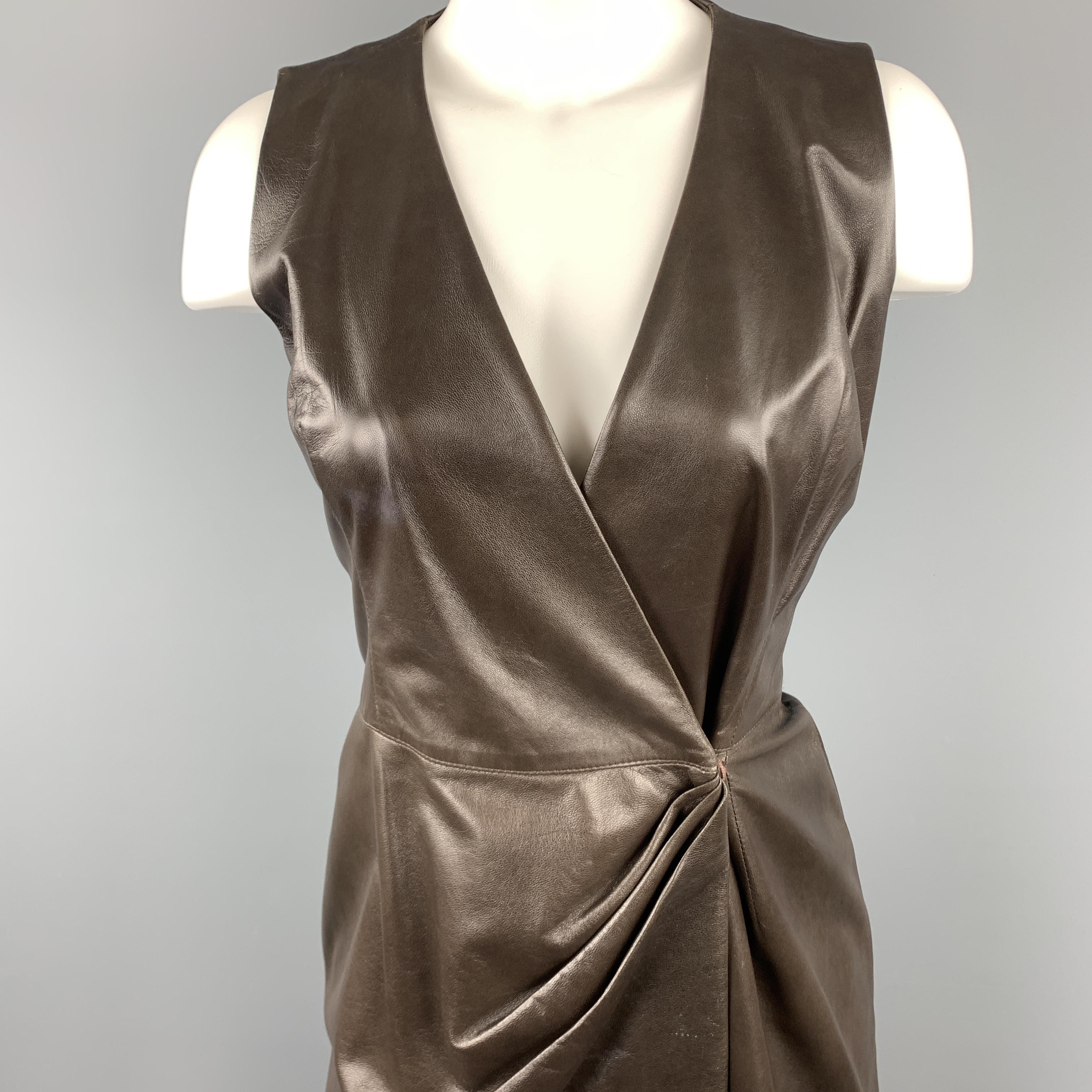 OSCAR DE LA RENTA wrap dress comes in soft brown leather with a V neck, pencil silhouette, and draped detail. Wear throughout leather. As-is. Made in USA.

Good Pre-Owned Condition.
Marked: 4

Measurements:

Shoulder: 13 in.
Bust: 34 in.
Waist: 28