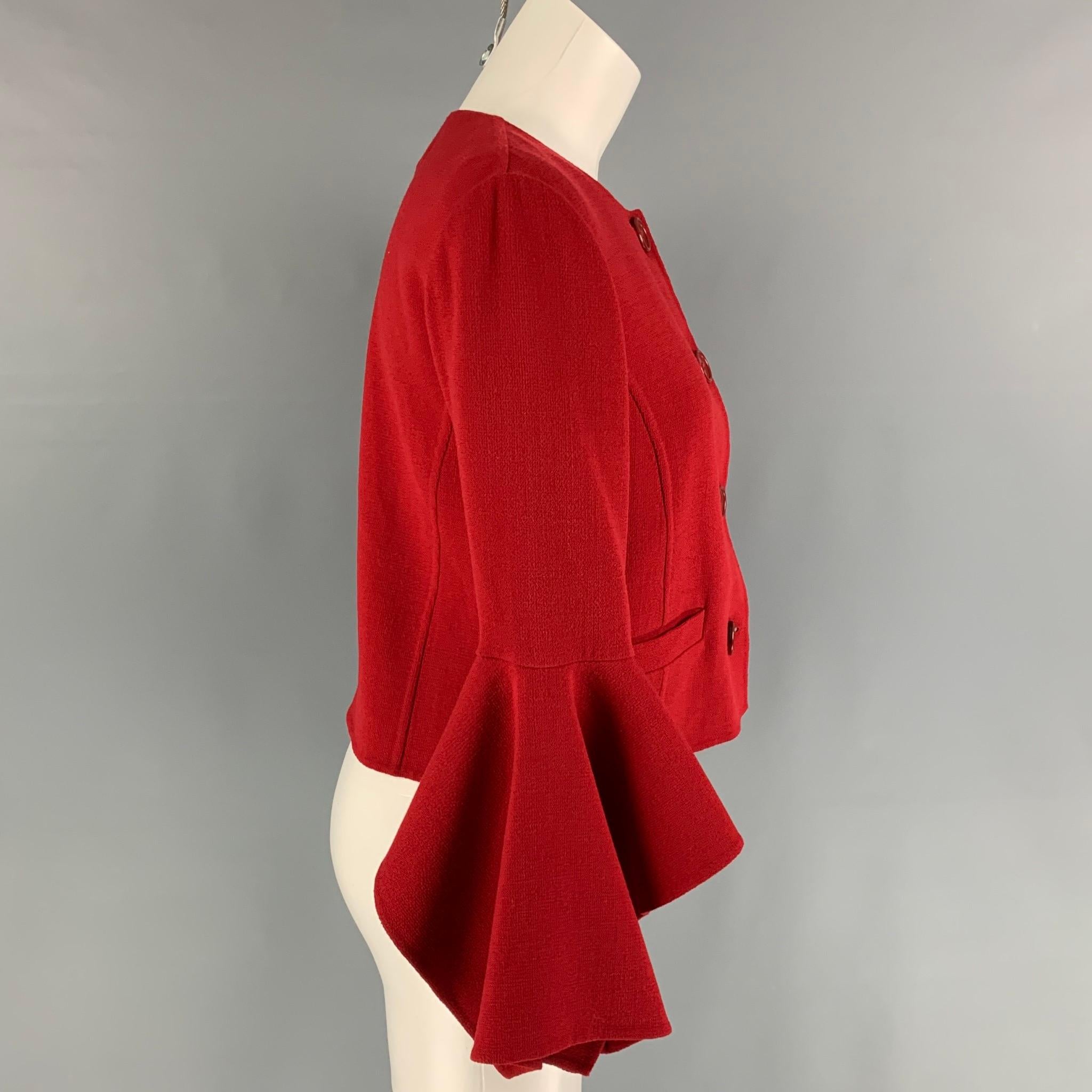OSCAR DE LA RENTA coat comes in a red virgin wool featuring a cropped style, ruffled sleeves, slit pockets, and a buttoned closure. Matching dress sold separately. Made in Italy. 

New With Tags. 
Marked: 4
Original Retail Price: