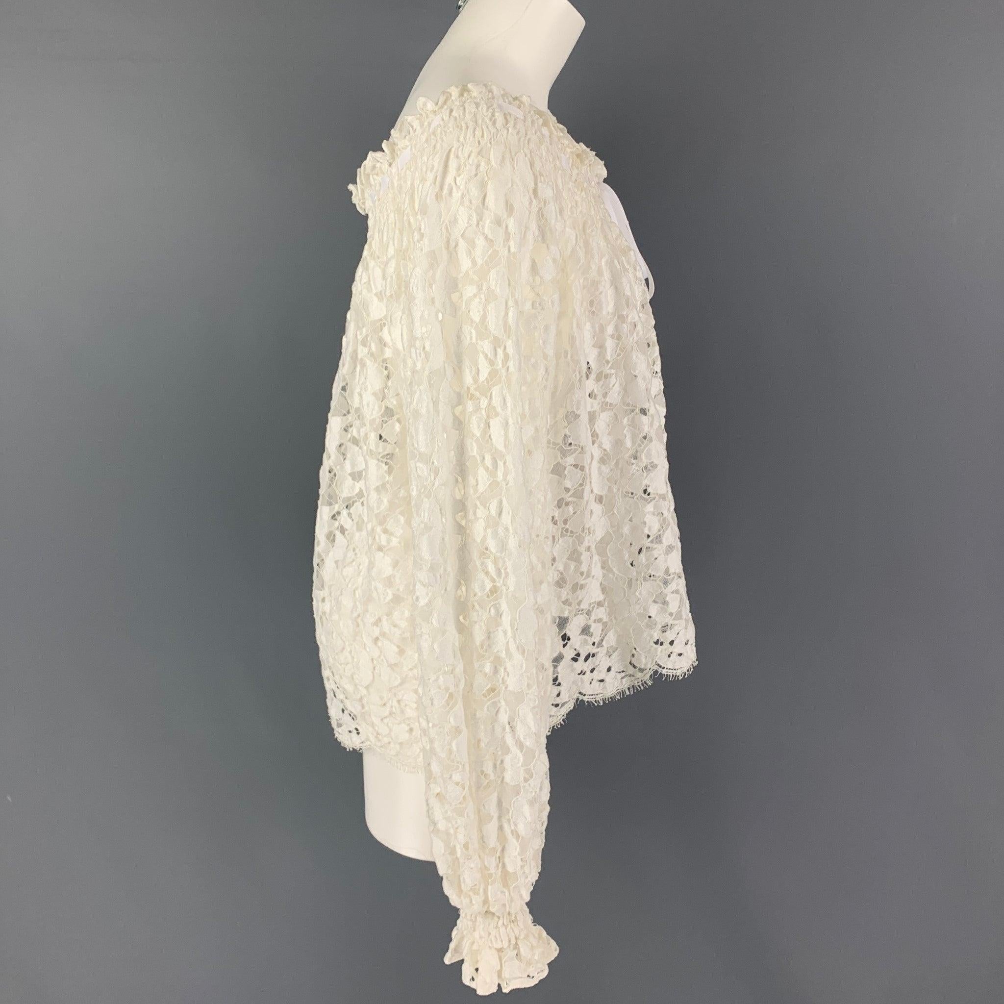 OSCAR DE LA RENTA dress top comes in a white see through lace cotton blend featuring a self tie ribbon design.
Good
Pre-Owned Condition. Light discoloration at front.  

Marked:   4 

Measurements: 
 
Shoulder: 16 inches  Bust: 42 inches  Sleeve: