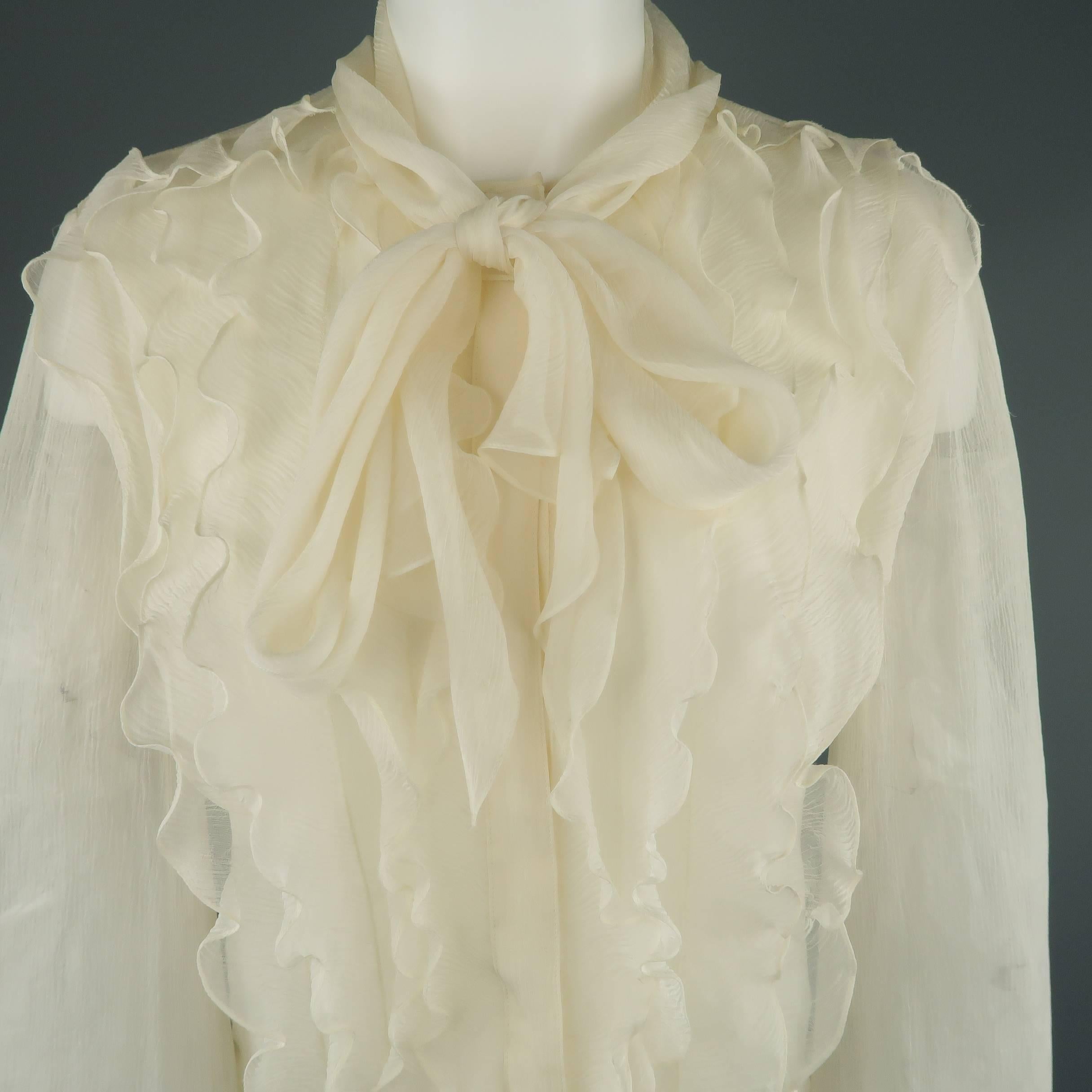 OSCAR DE LA RENTA blouse comes in light, creamy beige silk crepe chiffon with a subtle floral print, hidden placket snap closure, ruffled front, and tied collar. Minor wear. As-is. Made in USA.
 
Good Pre-Owned Condition.
Marked: 8
 
Measurements:
