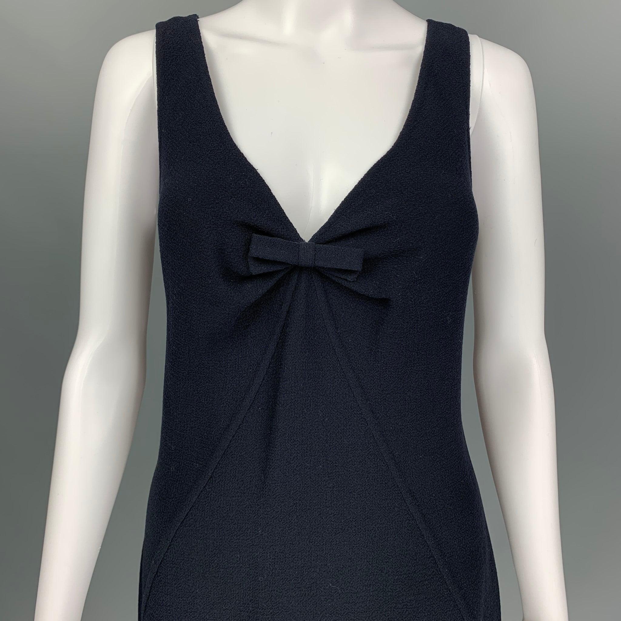 OSCAR DE LA RENTA for Saks Fifth Avenue Resort 2007 cocktail dress comes in a navy wool featuring a bow detail at center front, v-neck, sleeveless, center back invisible zip-up closure. Made in Italy. Excellent Pre-Owned Condition. 

Marked:   8