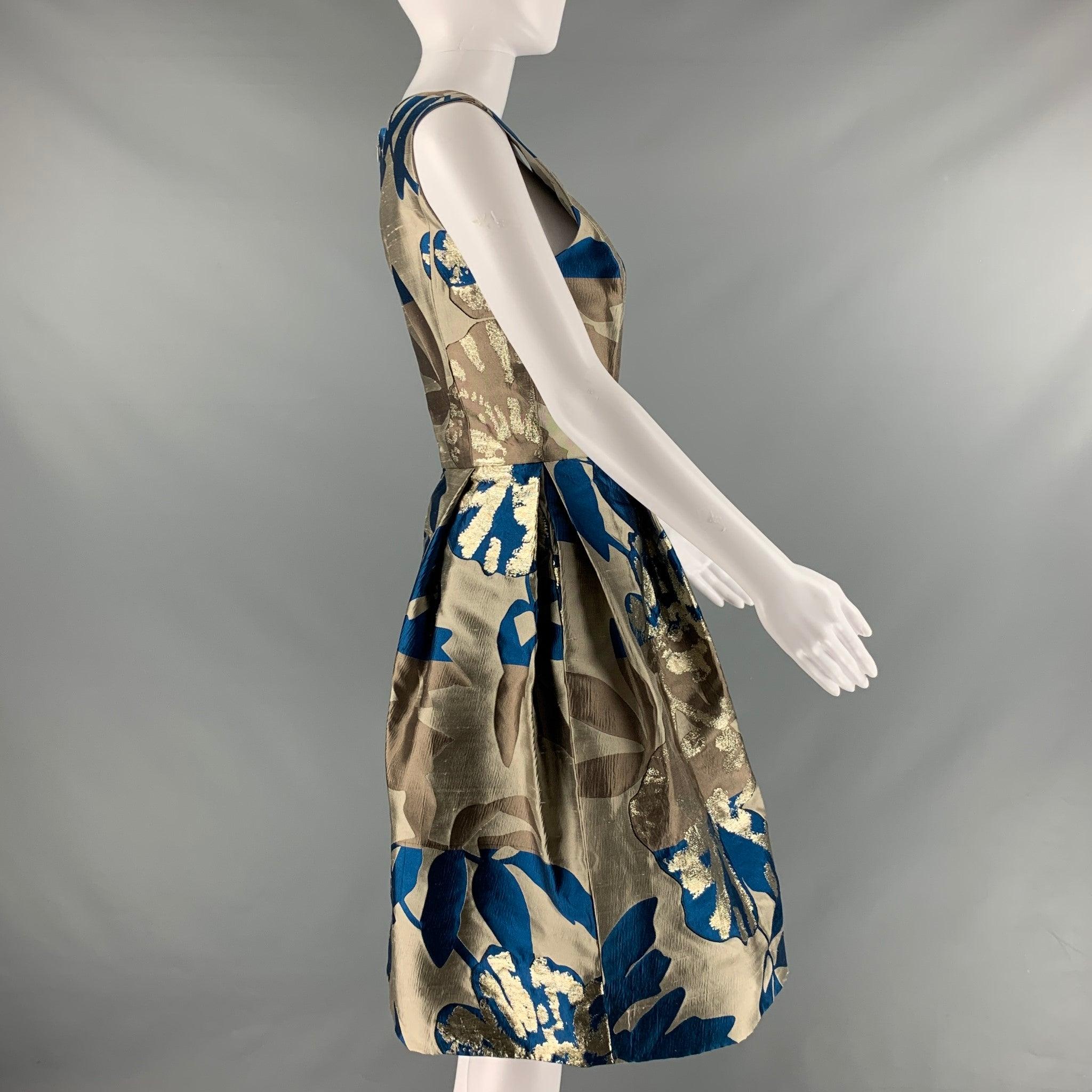 OSCAR DE LA RENTA S'09 cocktail dress comes in a taupe and blue floral silk and polyester jacquard featuring a round neckline, and pleated A line skirt with pockets. Made in USA.Excellent Pre-Owned Condition. 

Marked:  8 

Measurements: 
