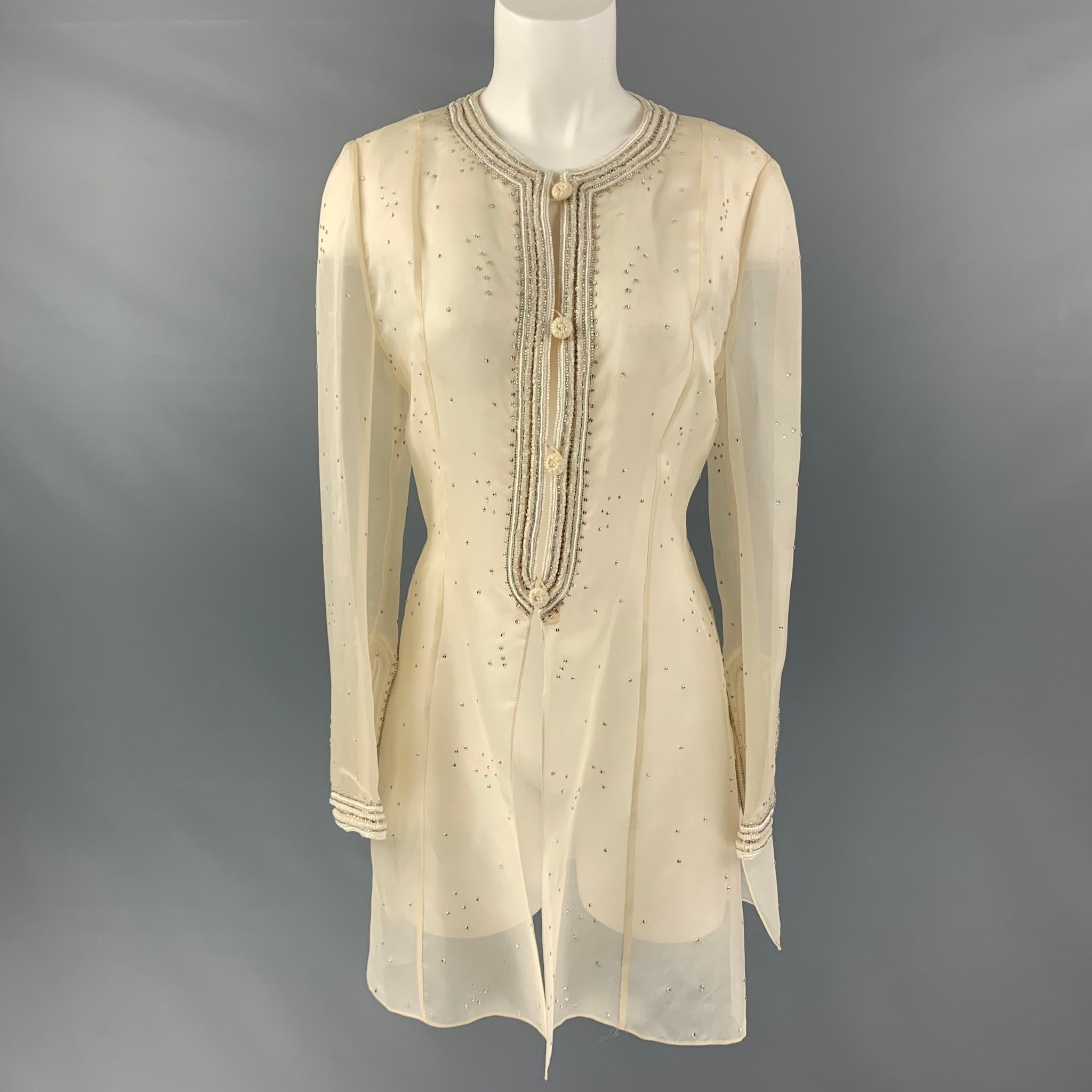 OSCAR DE LA RENTA tunic dress comes in cream silk fabric featuring a beaded embroidery details, long sleeve and button closure. Made in USA.

Very Good Pre-Owned Condition. Minor Signs of Wear.
Marked: no size marked

Measurements:

Shoulder: 14