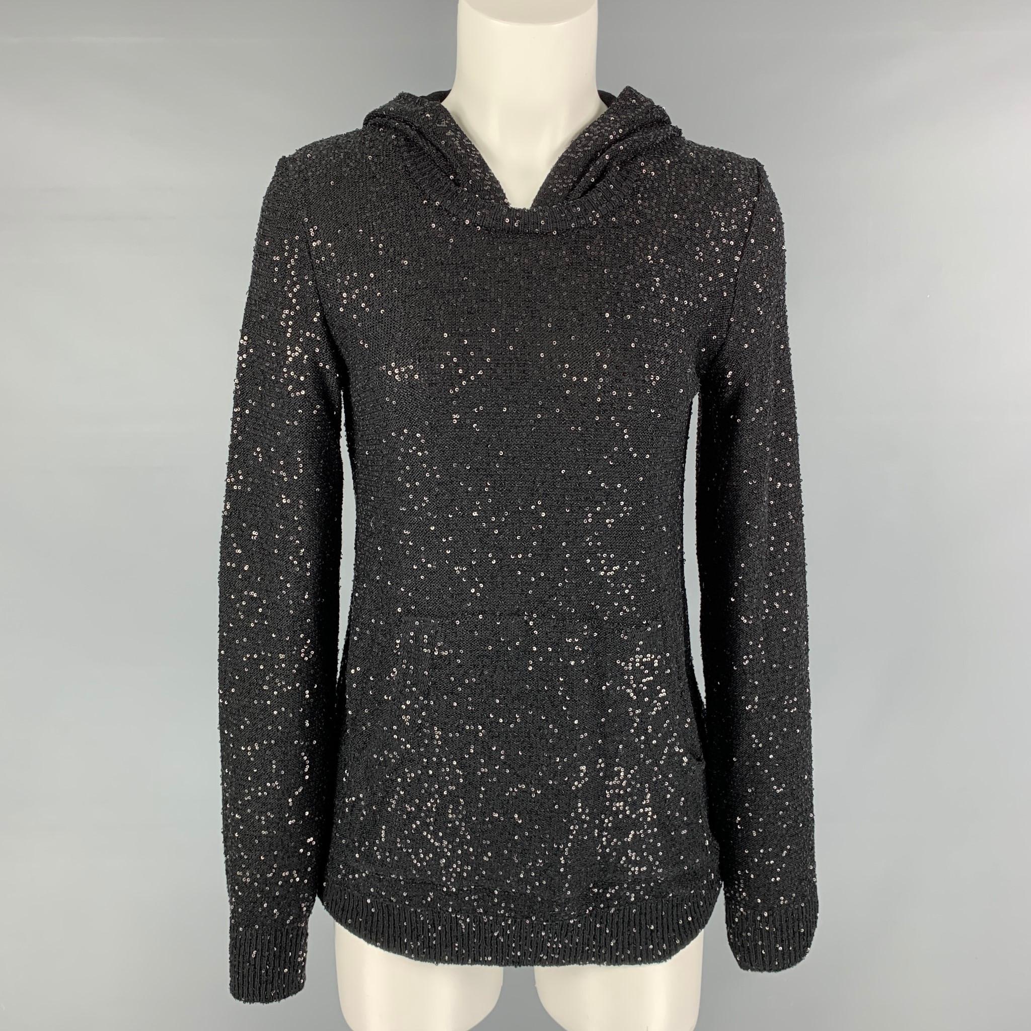 OSCAR DE LA RENTA 'pre fall 2012' hooded pullover comes in black knitted silk and polyester featuring a sequins and frontal pocket. Made in Italy.

Excellent Pre-Owned Condition.
Marked: S

Measurements:

Shoulder: 14.5 in.
Bust: 39 in.
Sleeve: 27